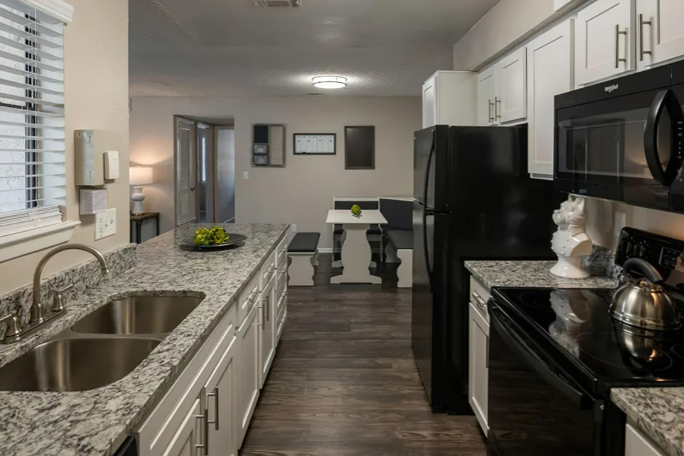 a modern kitchen with stainless steel appliances and wooden cabinets