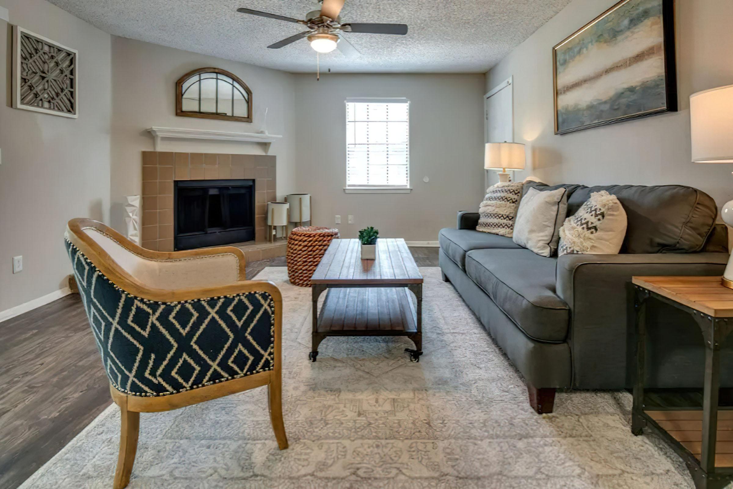 a living room filled with furniture and a fireplace