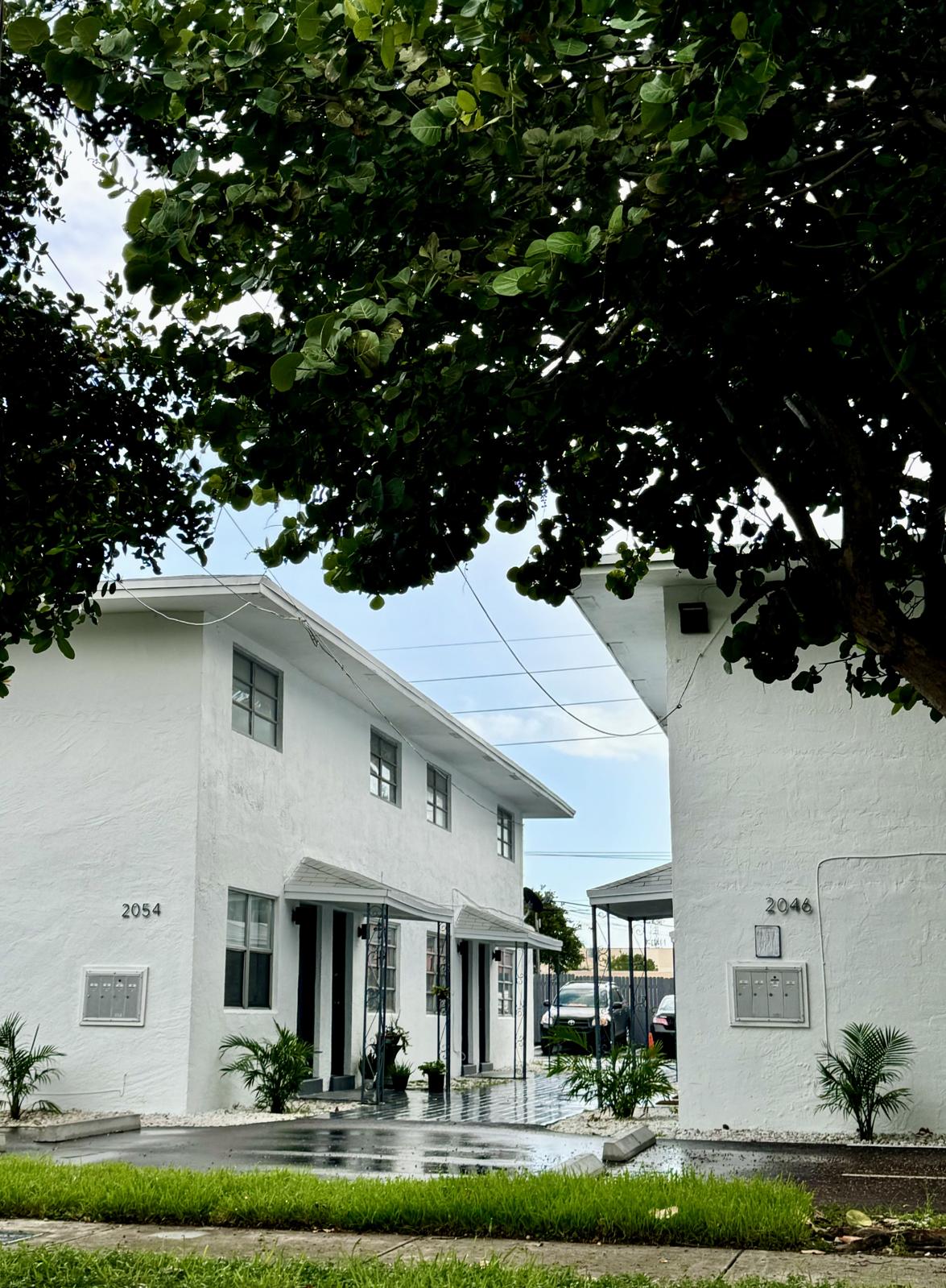 a house with bushes in front of a building