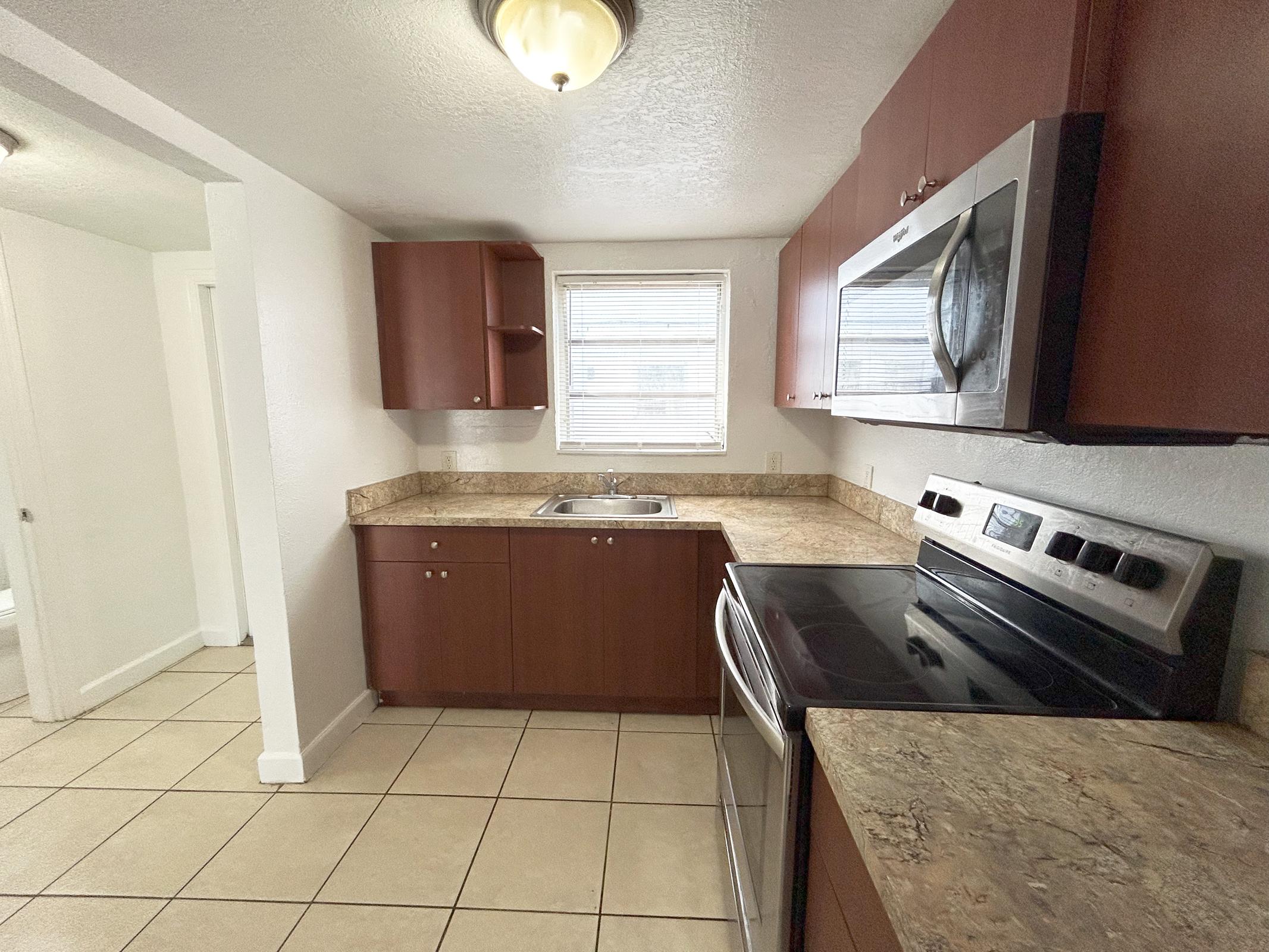 a stove top oven sitting inside of a kitchen