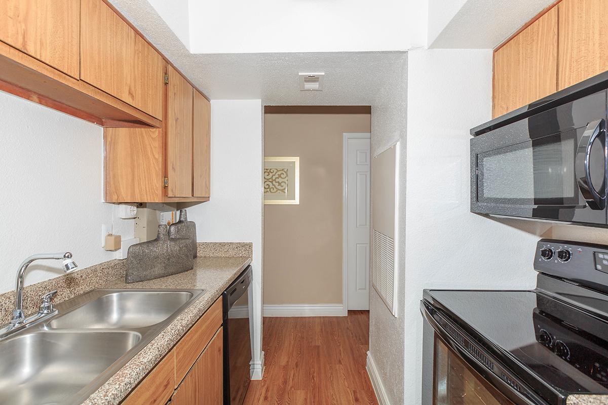 a kitchen with stainless steel appliances and wooden cabinets