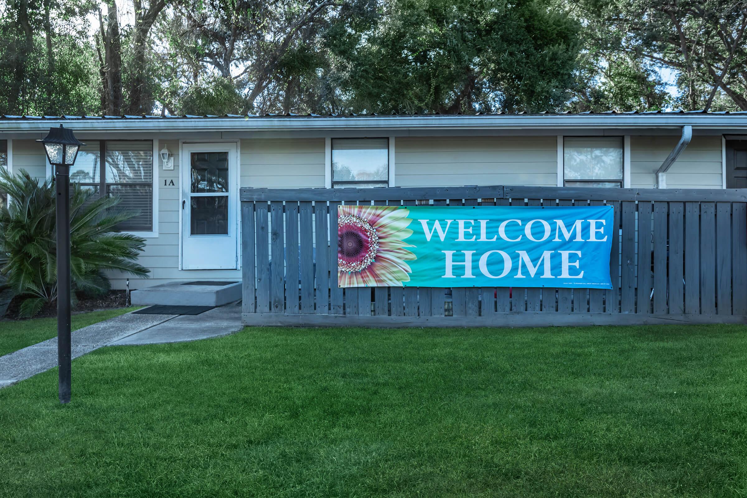 a sign in front of a house