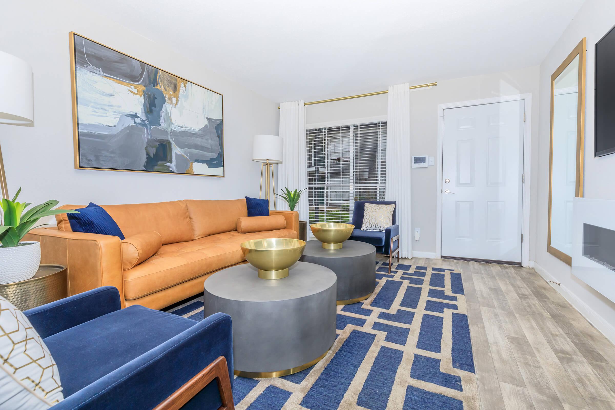 a living room filled with furniture and a large window