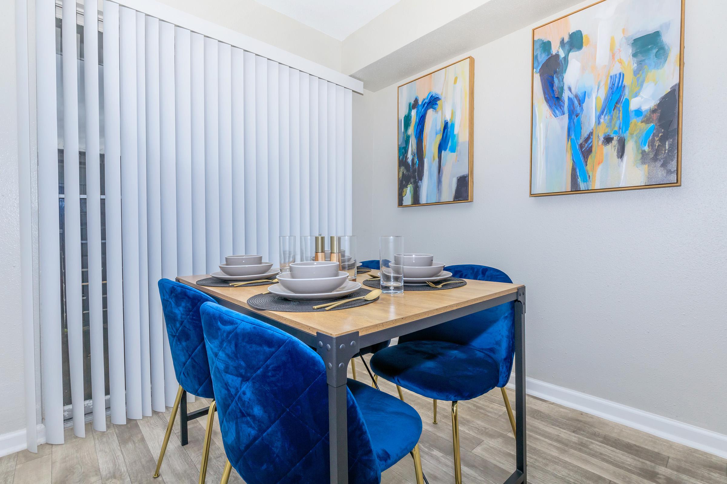 a table topped with a blue chair