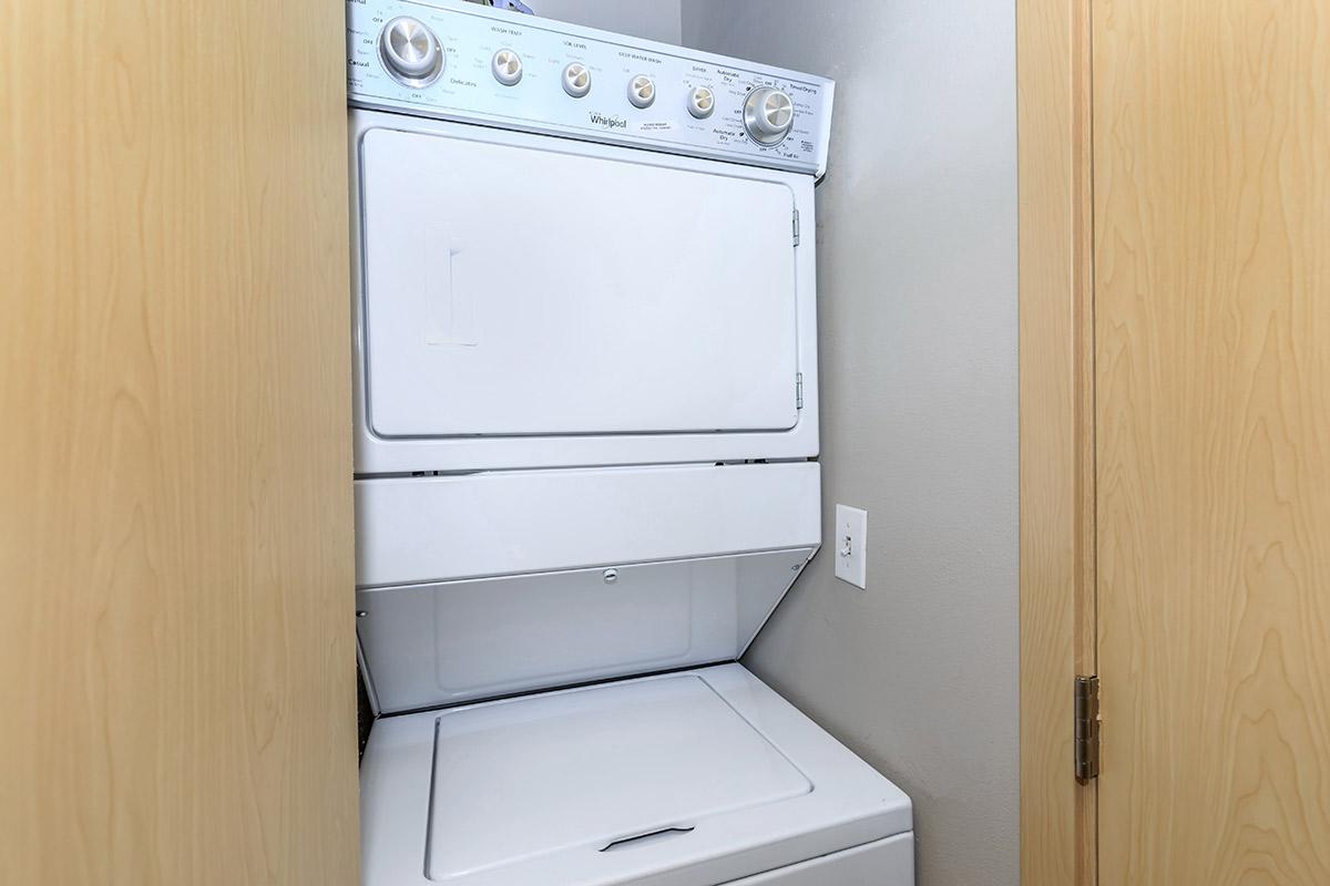 a white microwave oven sitting on top of a wooden door