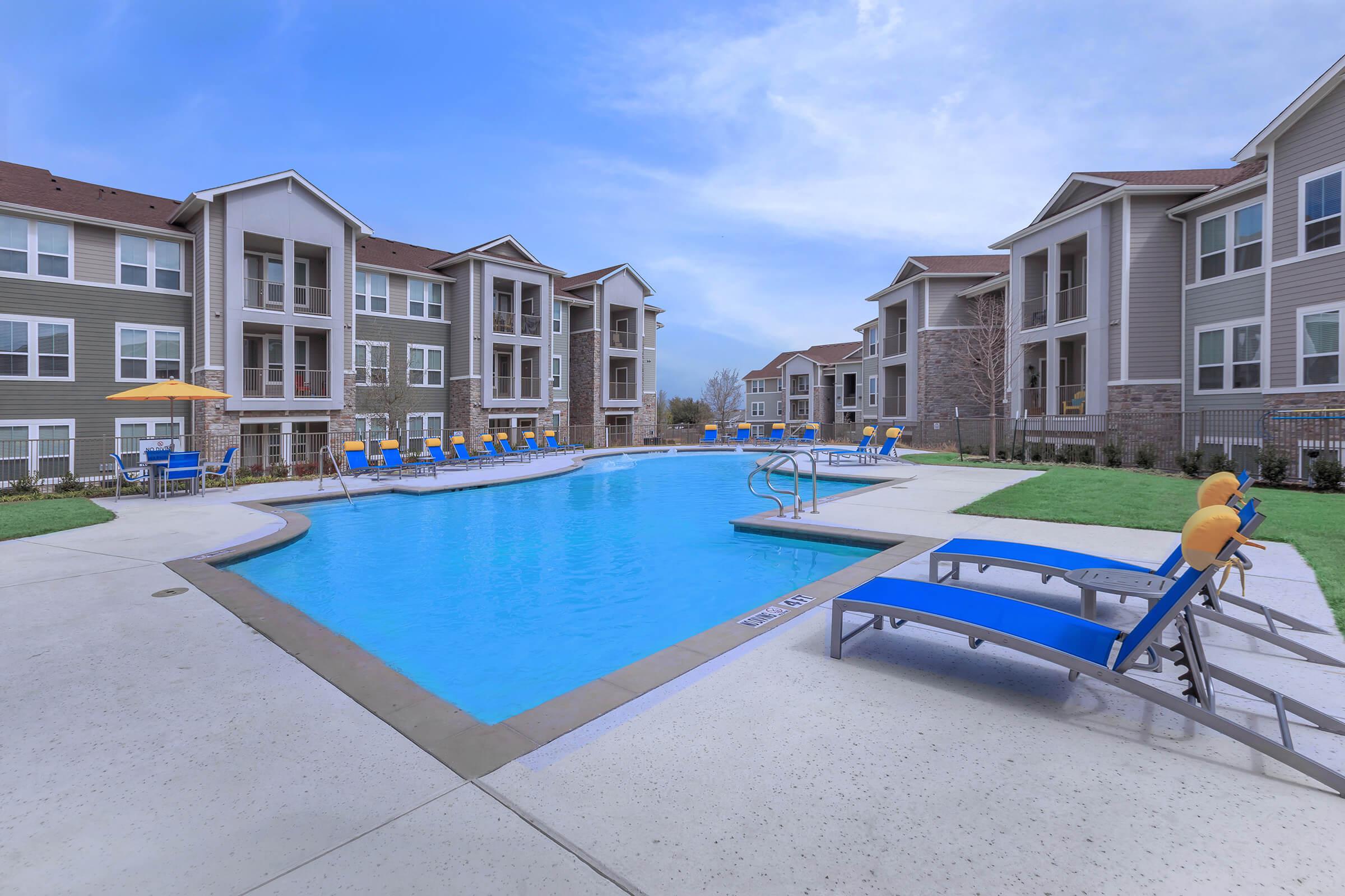 a blue pool of water in front of a building