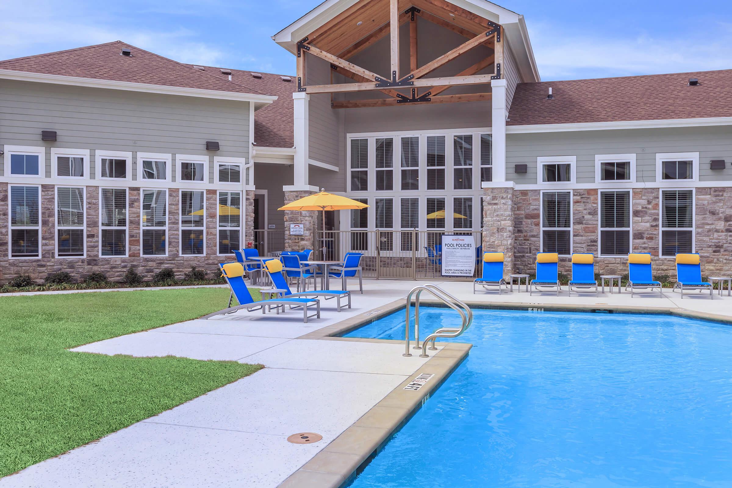 a house with a pool in front of a building