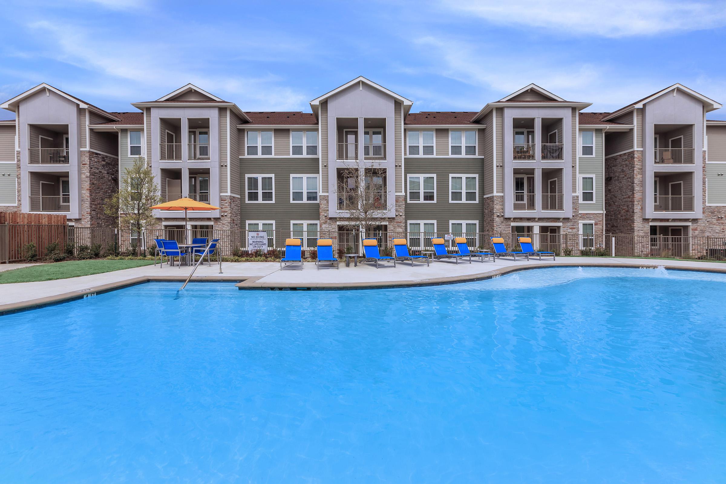 a blue pool of water in front of a building