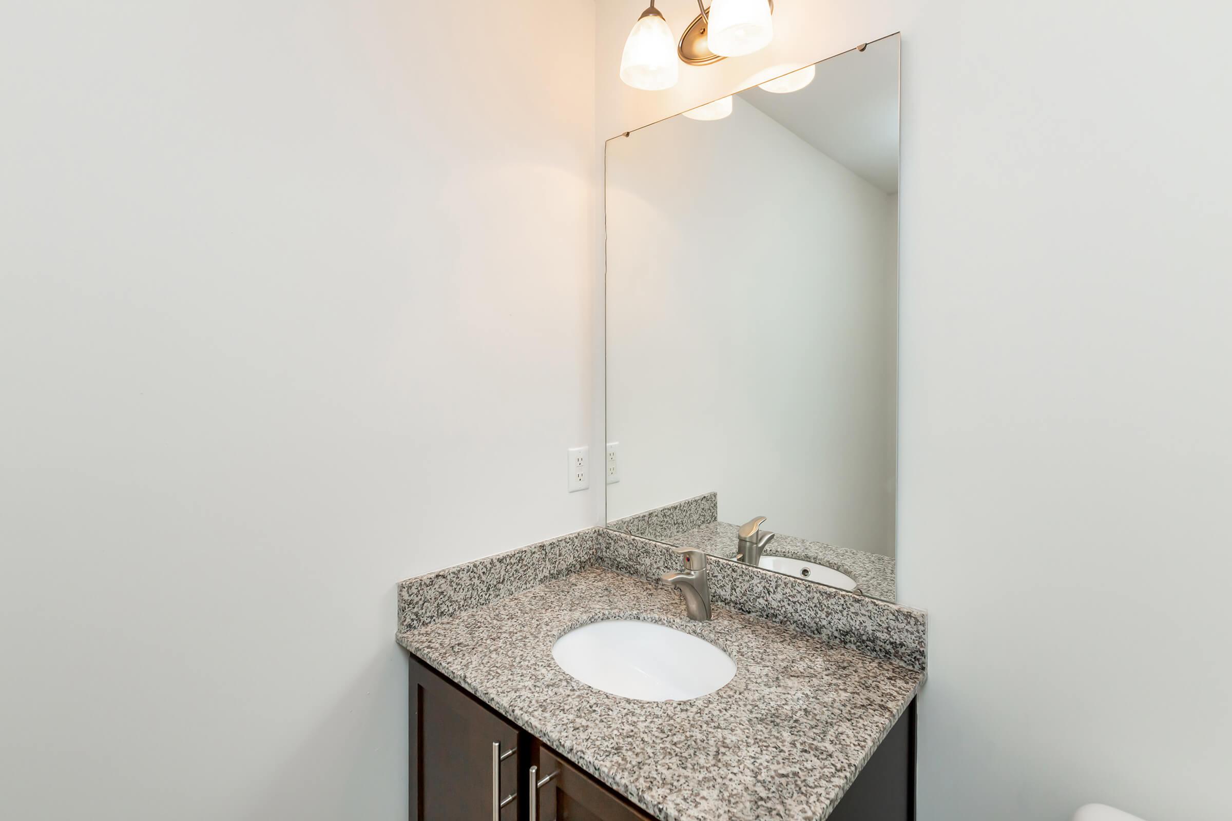 a white sink and a mirror