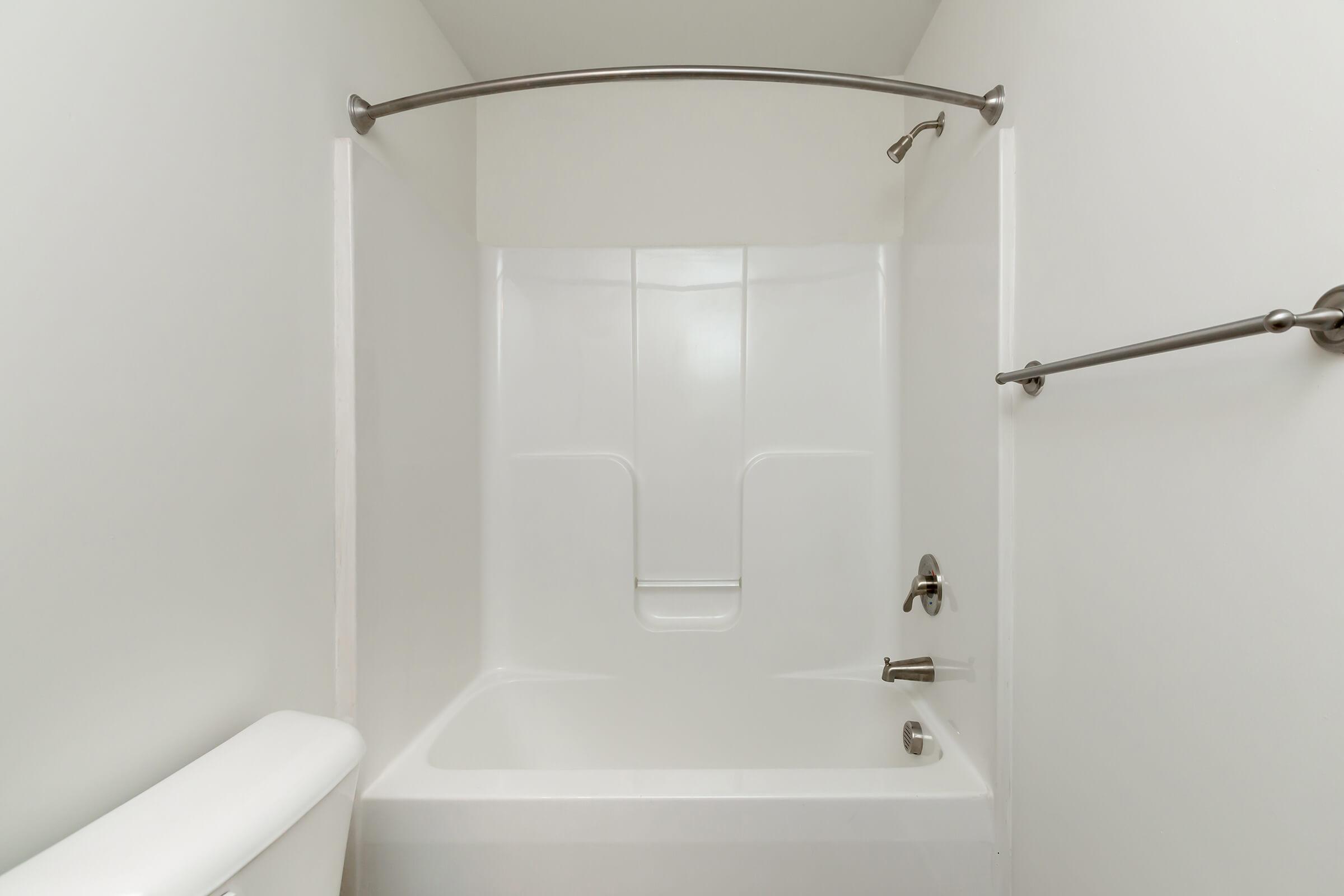 a white tub sitting next to a shower