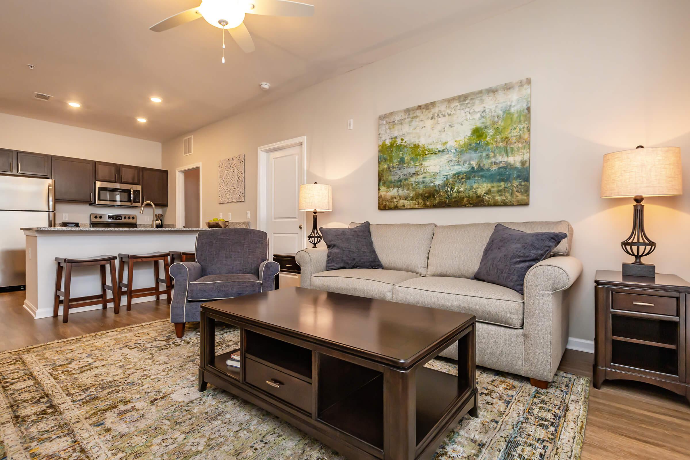 a living room filled with furniture and a flat screen tv