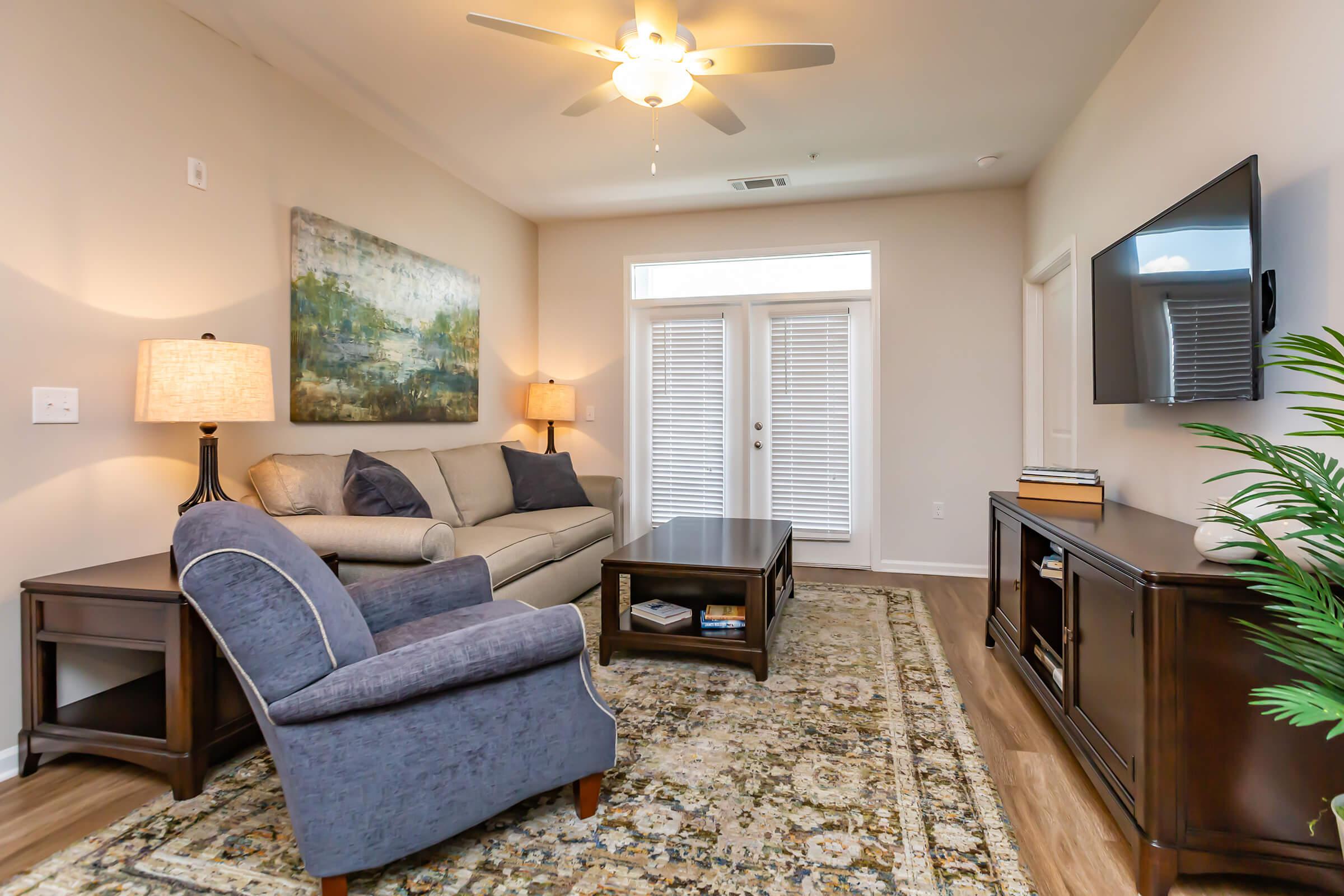 a living room filled with furniture and a flat screen tv