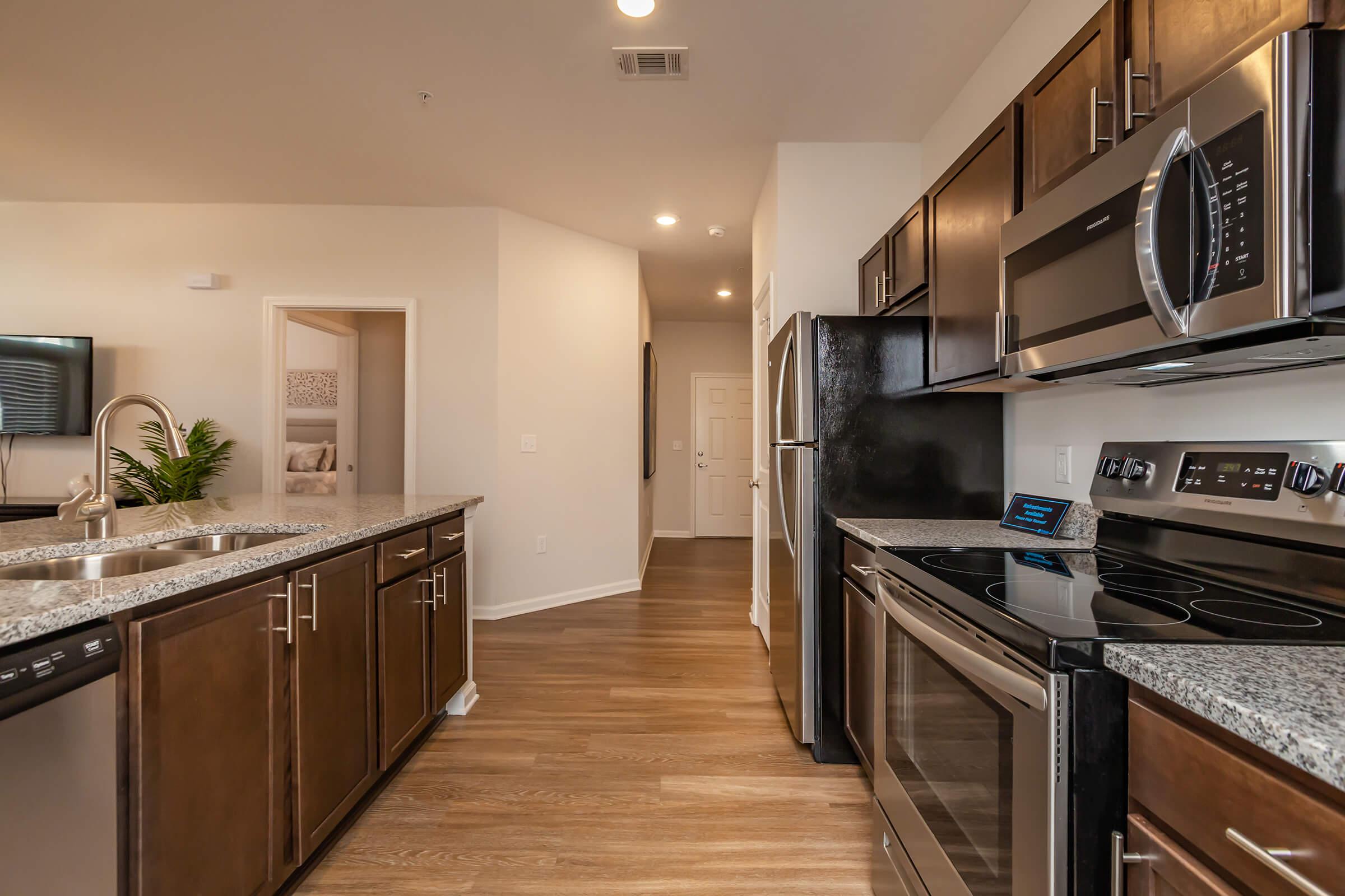 a modern kitchen with stainless steel appliances and wooden cabinets