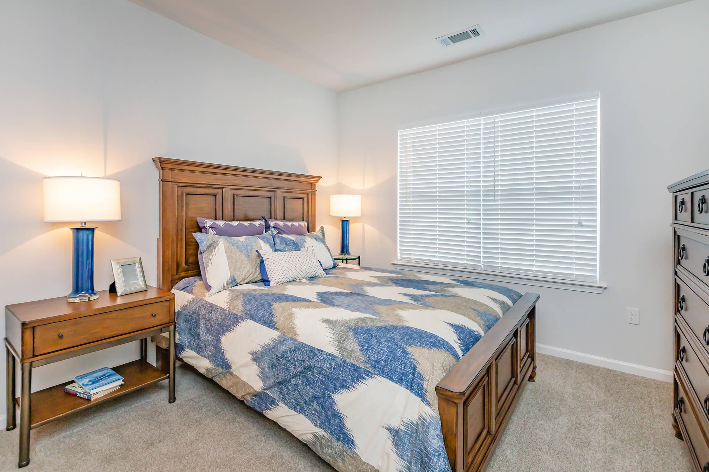 a bedroom with a bed and desk in a room