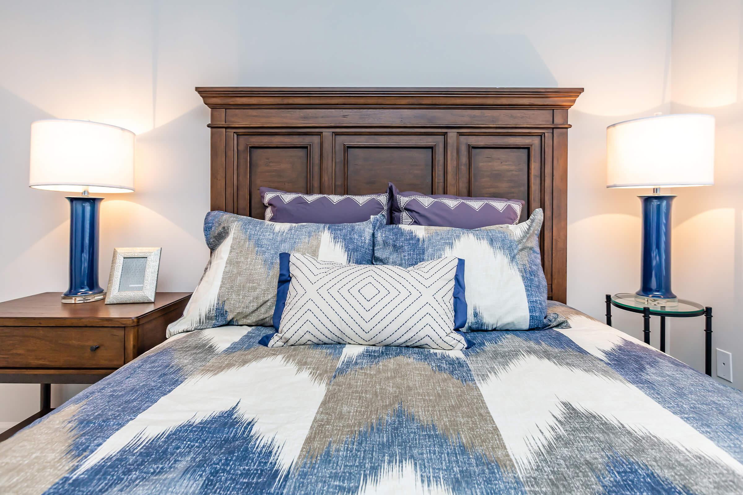 a bedroom with a bed and desk in a room