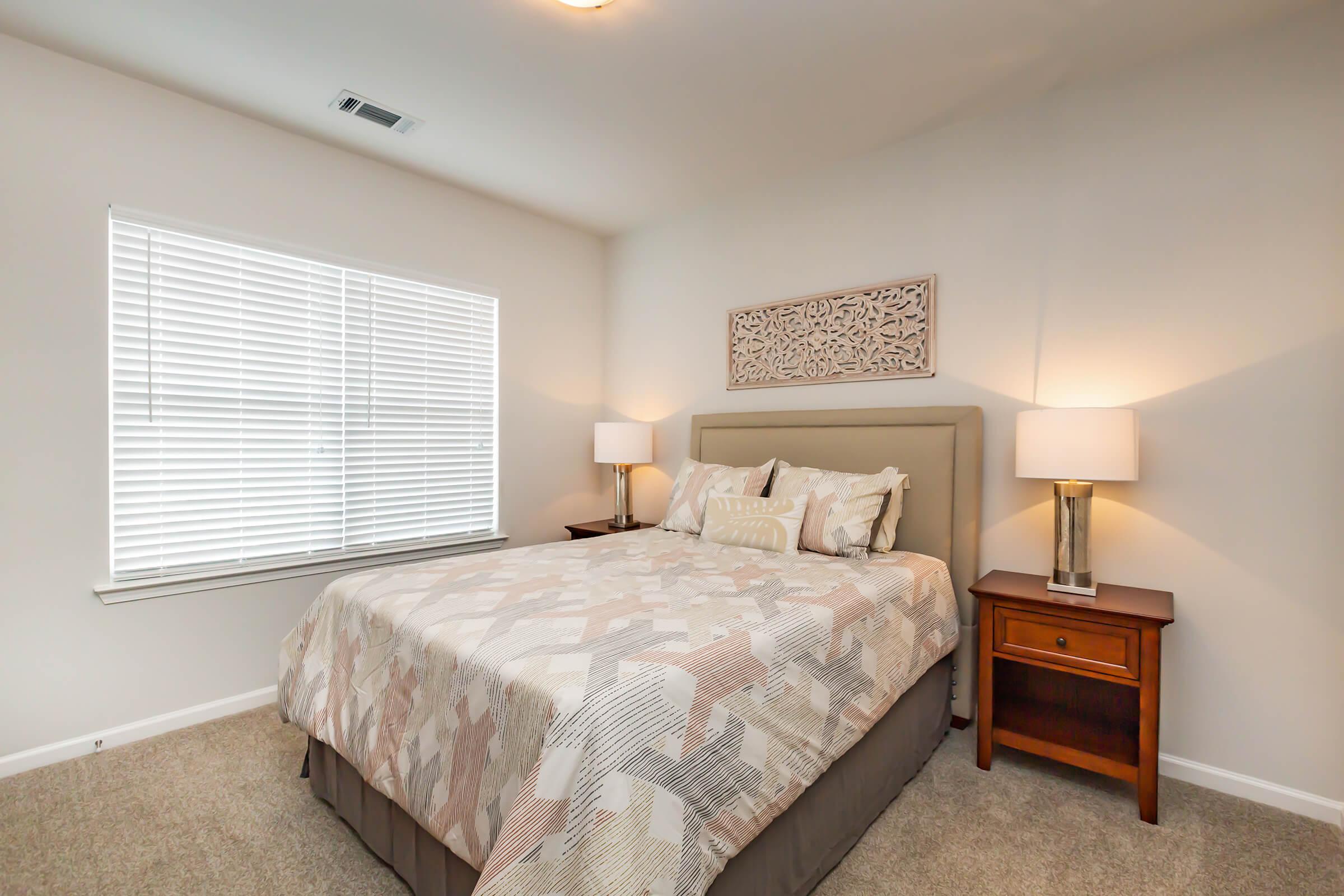 a bedroom with a bed in a room