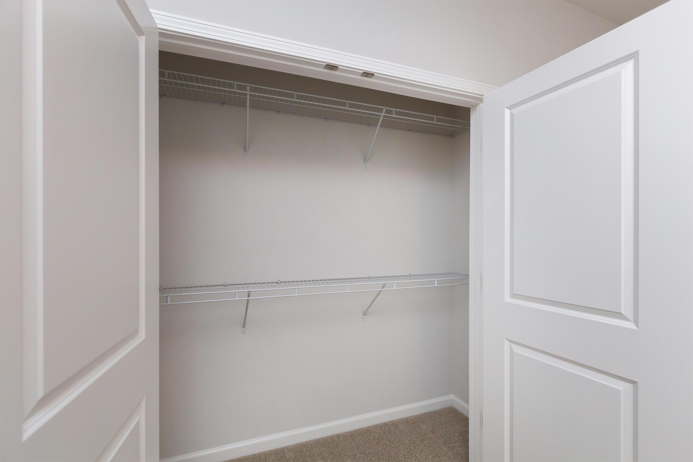 a white refrigerator freezer sitting next to a shower