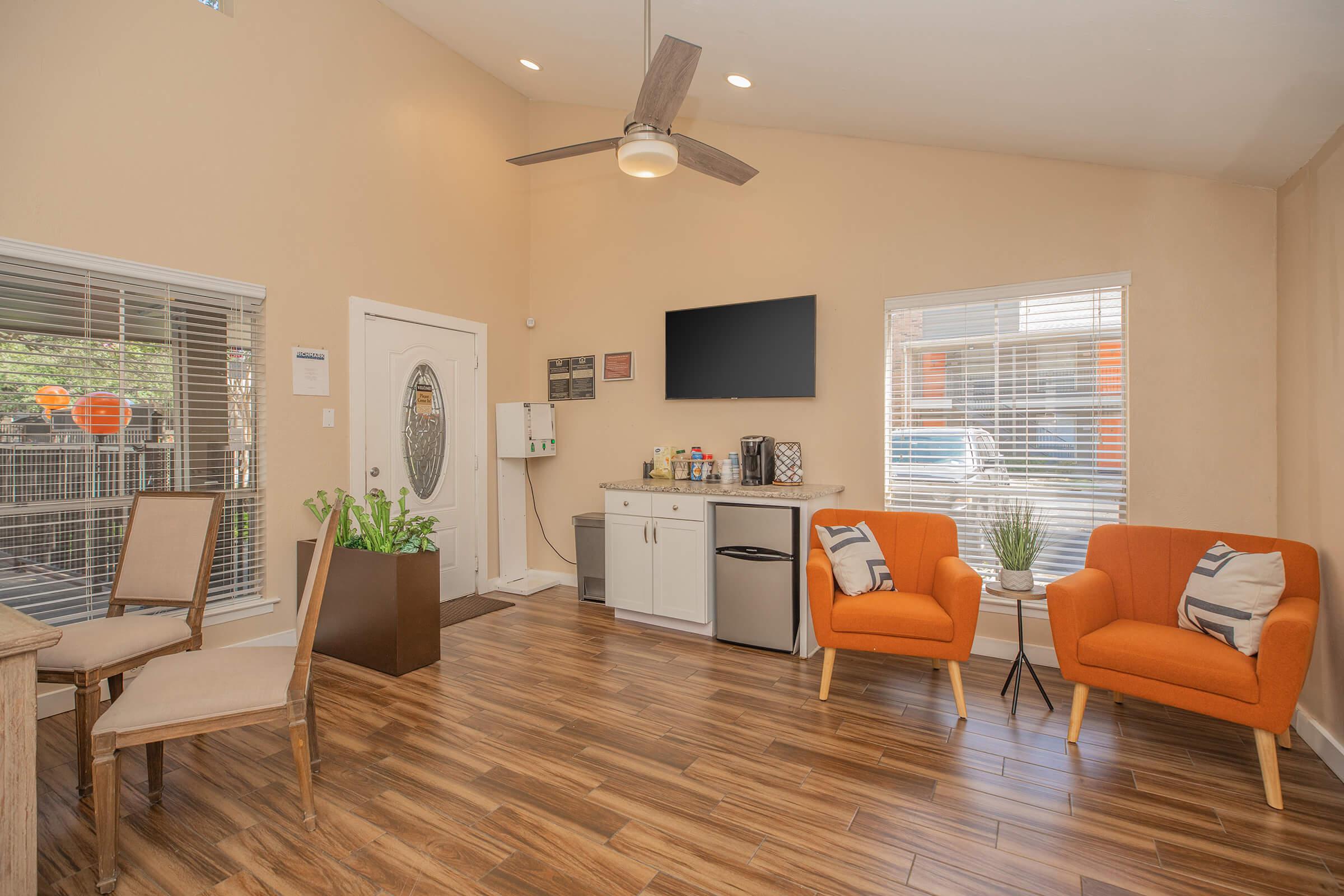 a living room filled with furniture and a large window