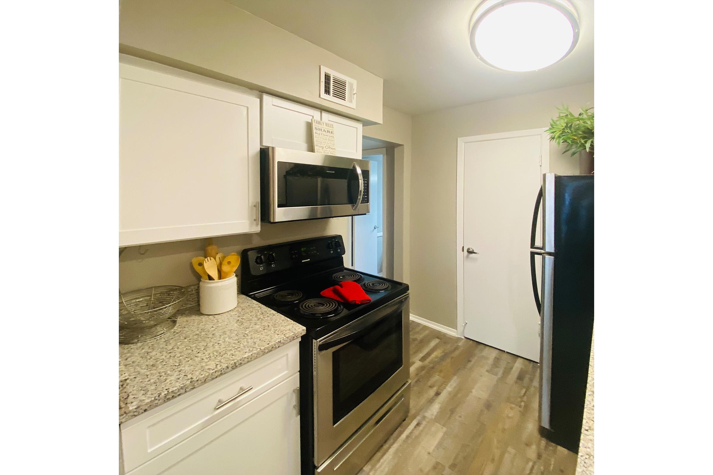 a kitchen with a stove and a refrigerator