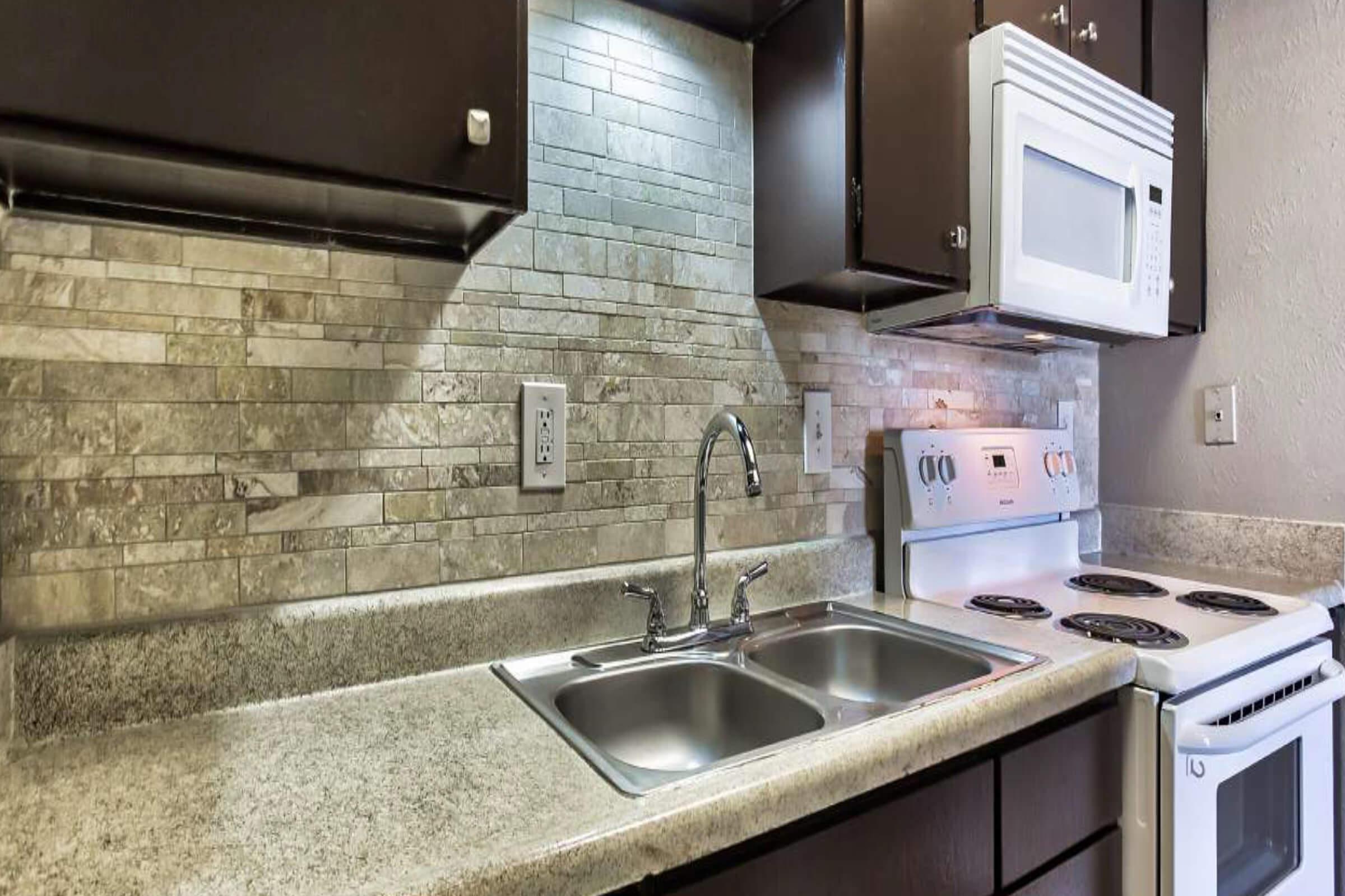 a stove top oven sitting inside of a kitchen