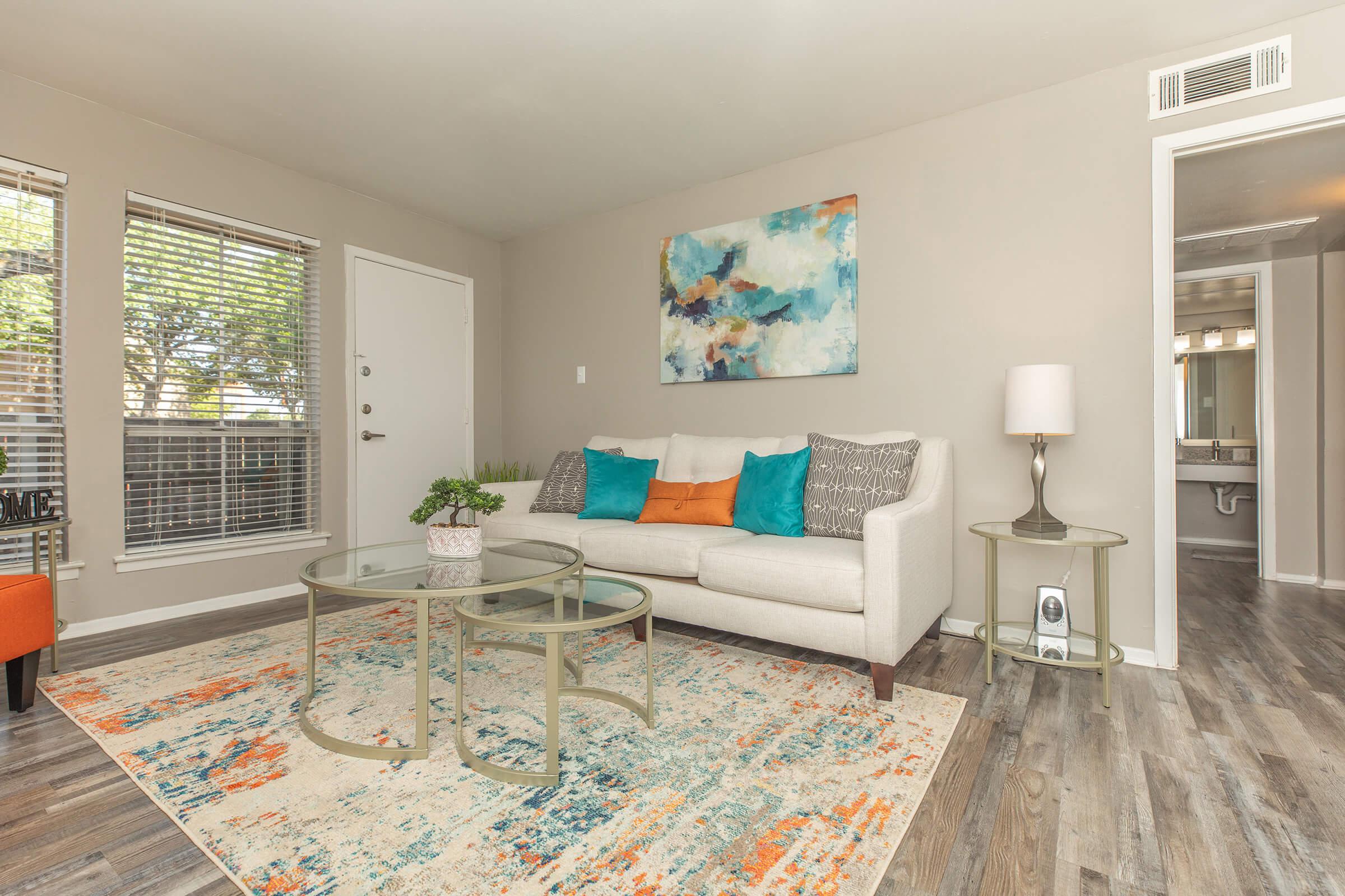 a living room filled with furniture and a large window