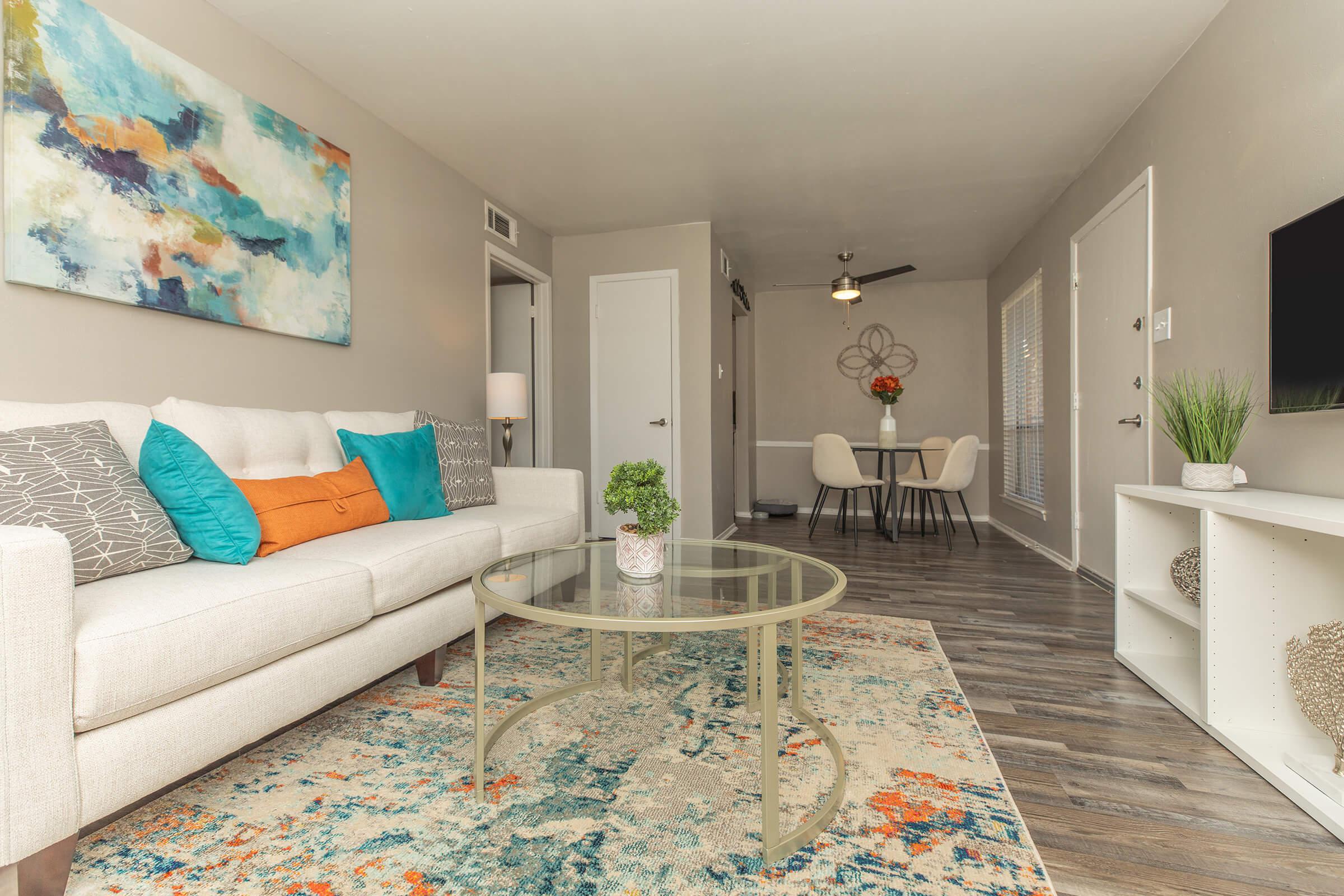 a living room filled with furniture and a rug