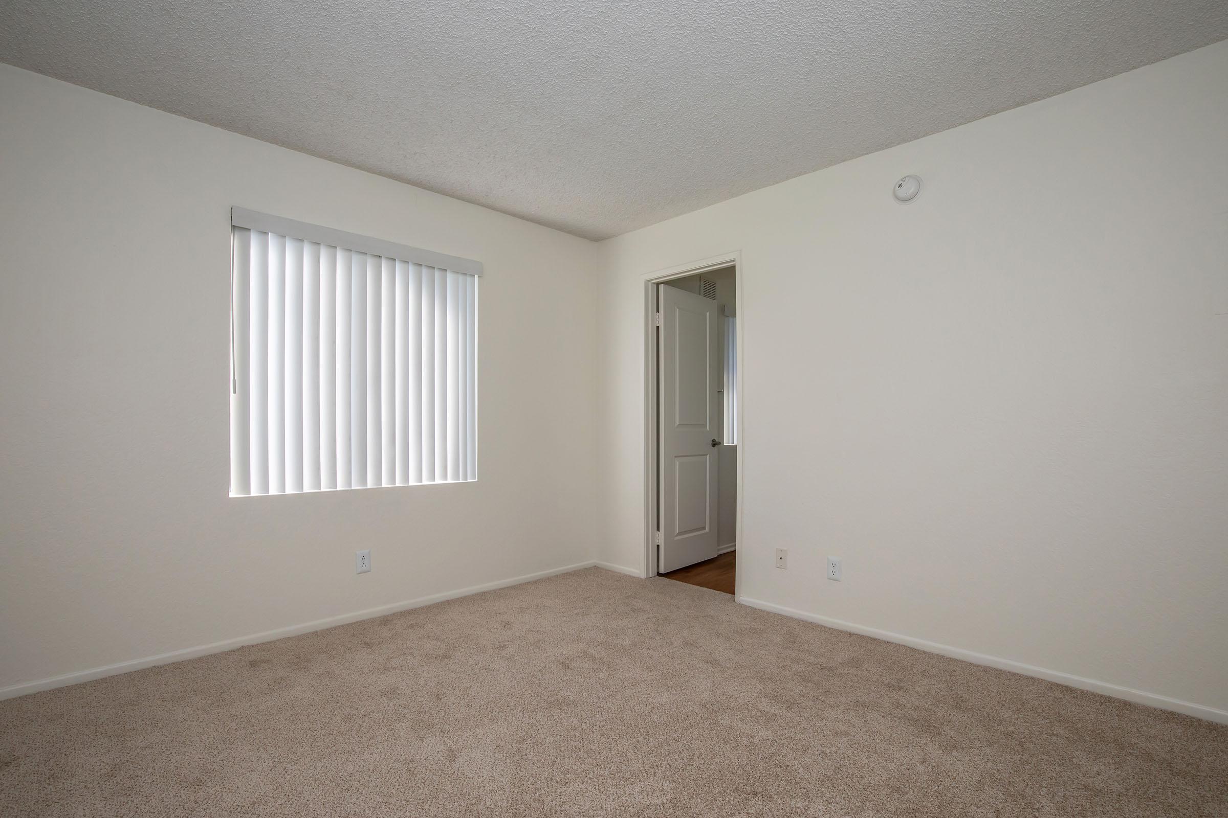 carpeted bedroom with a window