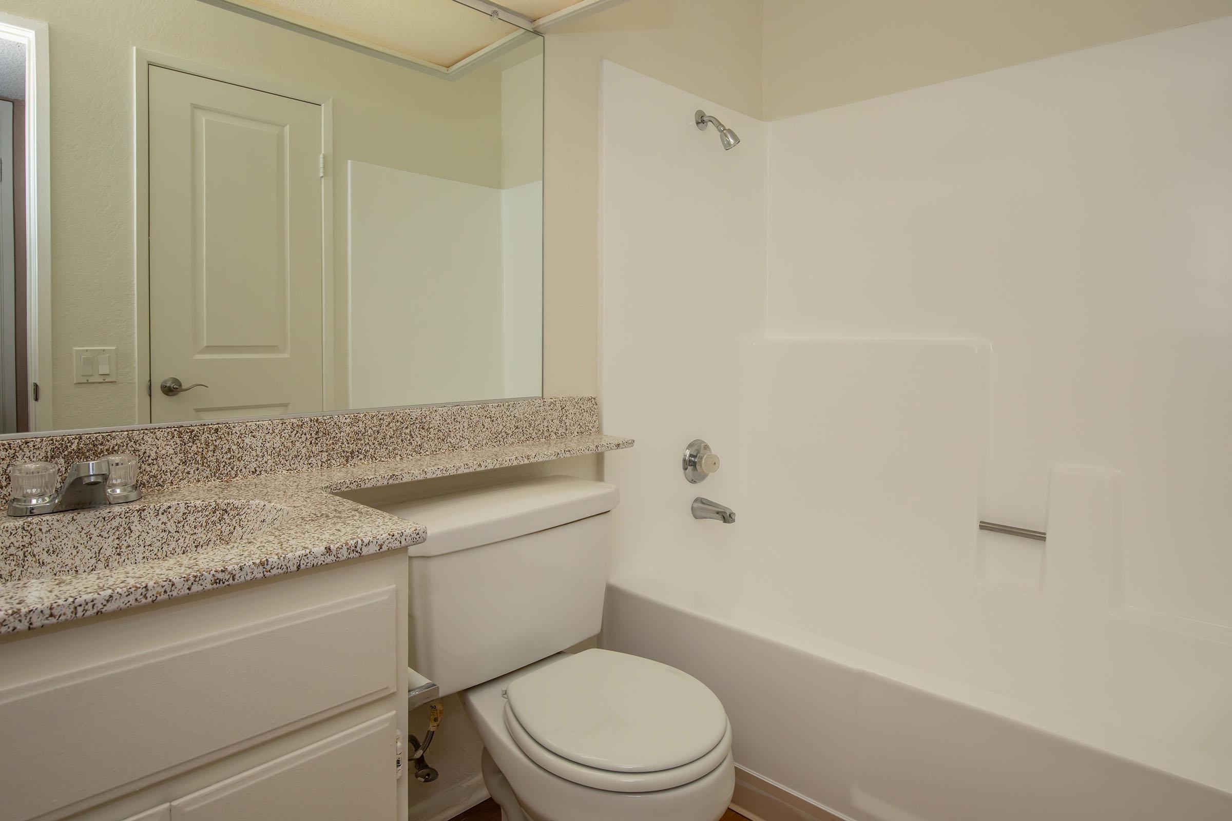 vacant bathroom with granite countertops