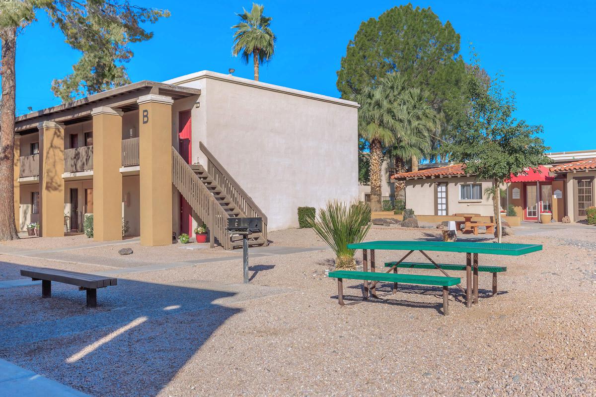 Whispering Pines courtyard with a green picnic table