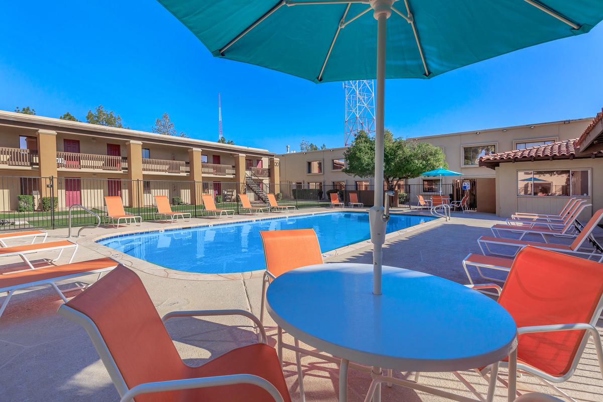 The community pool with blue umbrellas