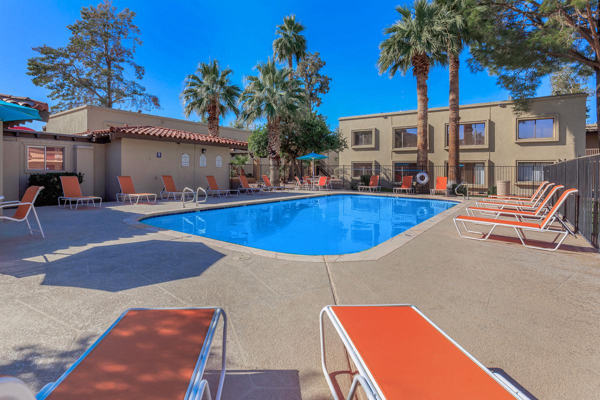 Whispering Pines community pool with green trees