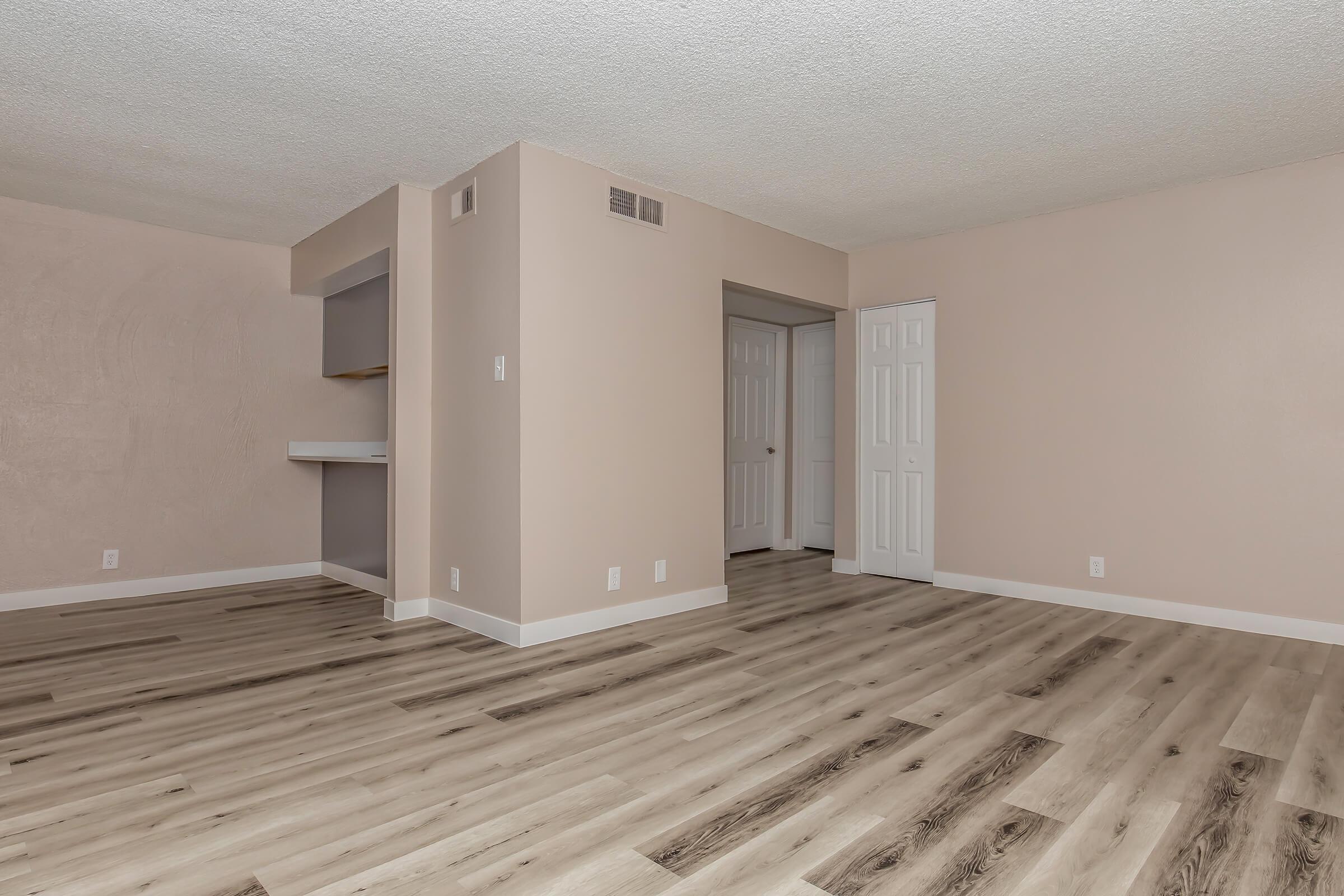 a large empty room with a wooden floor