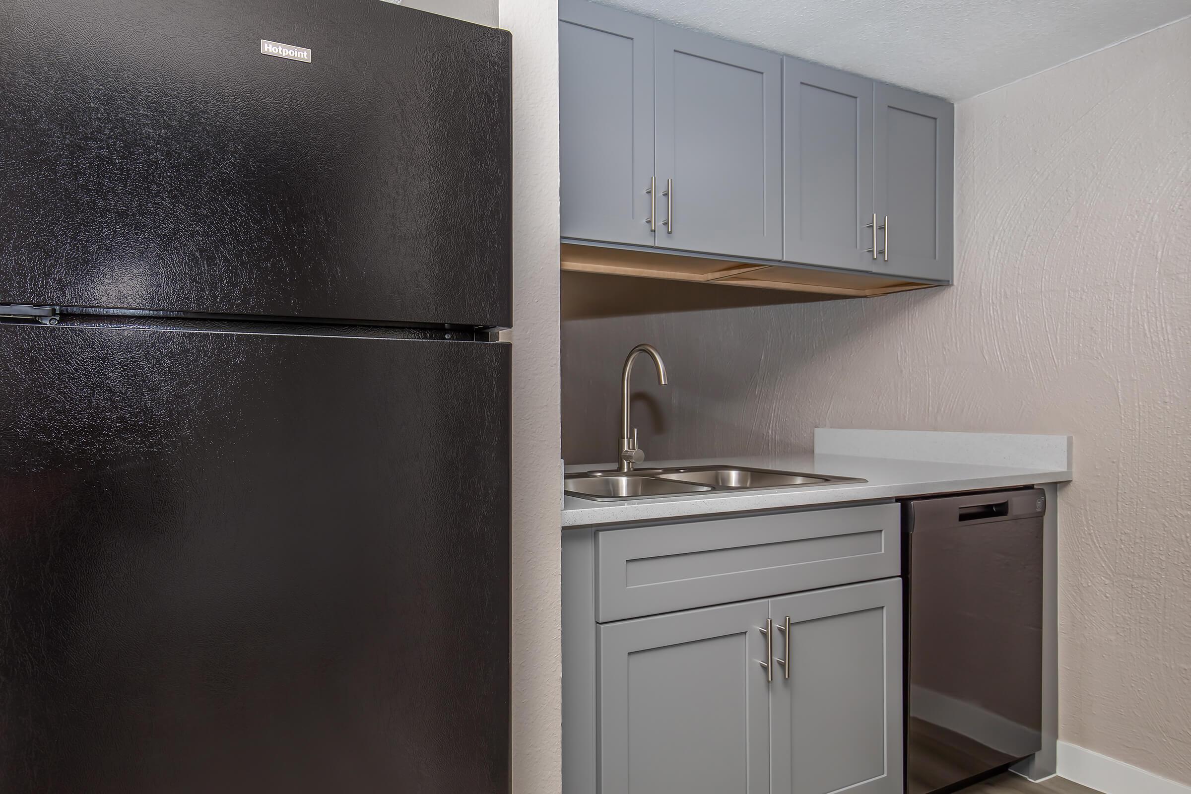 a kitchen with a sink and a refrigerator