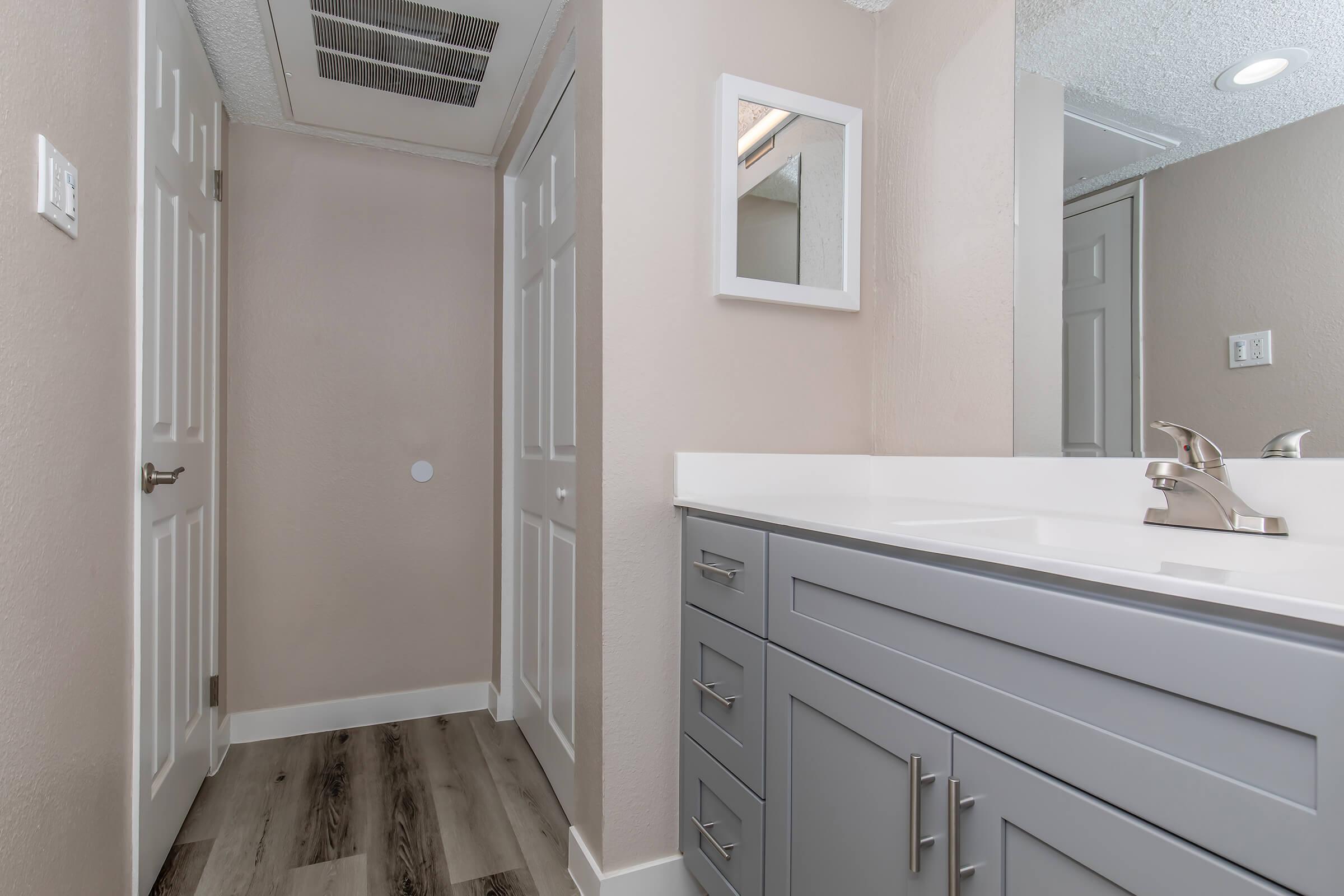 a kitchen with a sink and a mirror