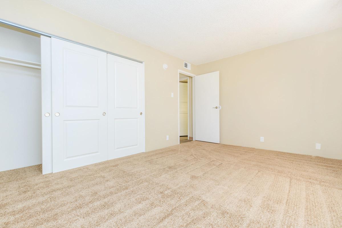 Bedroom with open sliding closet doors