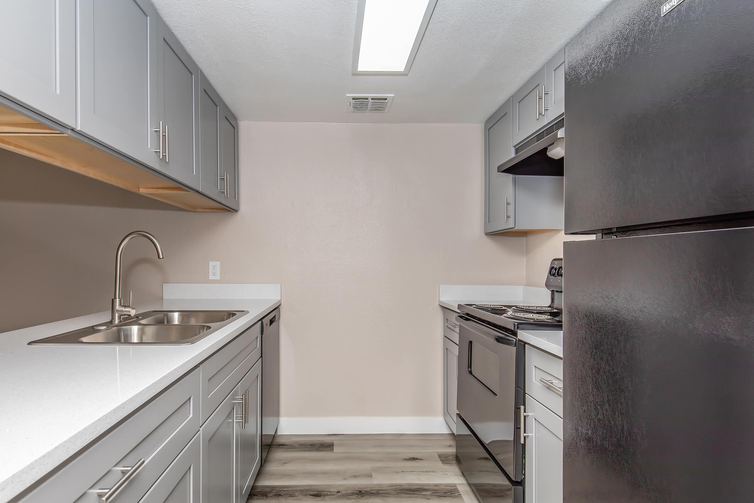 a kitchen with a stove sink and refrigerator