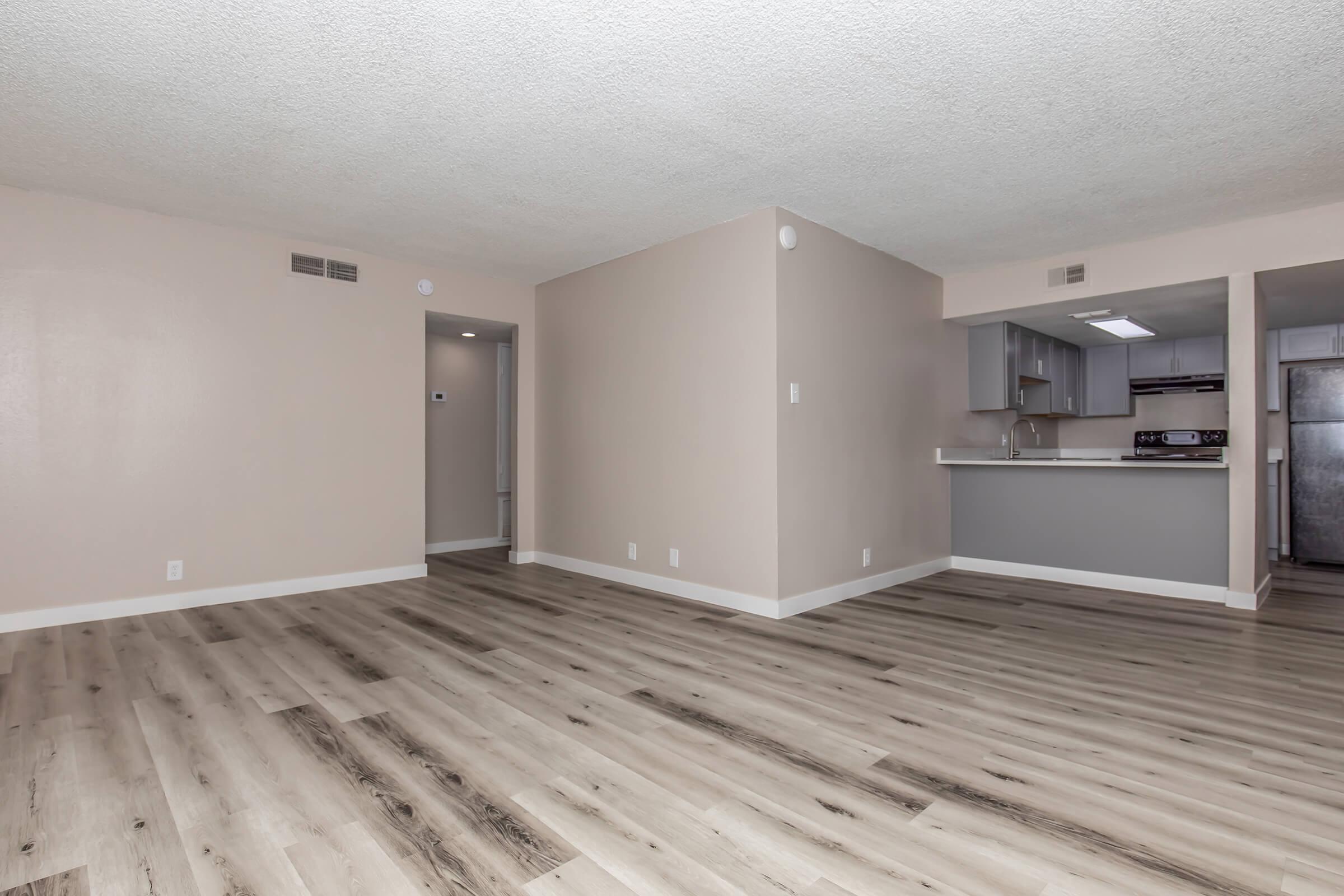 a large empty room with a wood floor