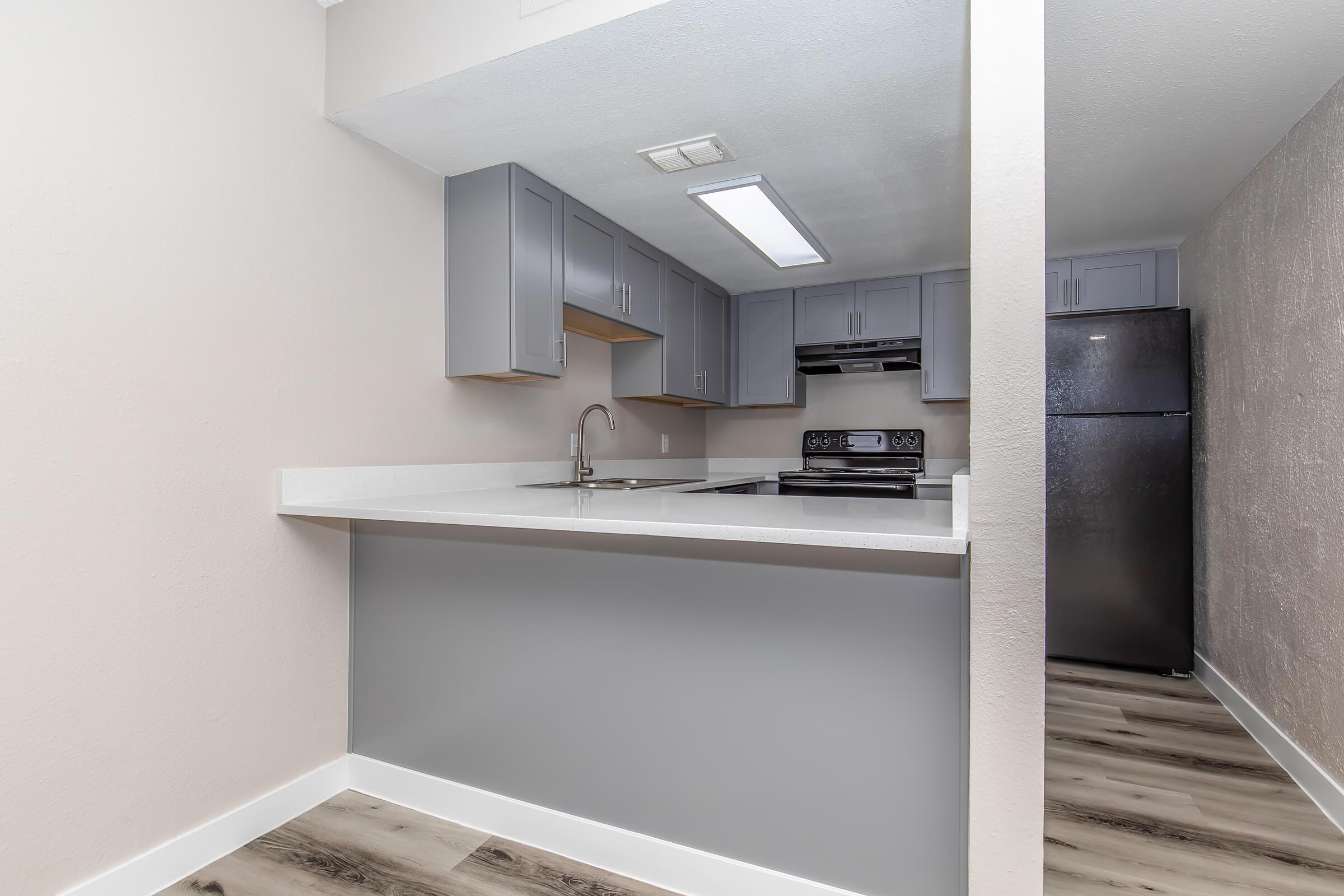 a kitchen with a sink and a mirror