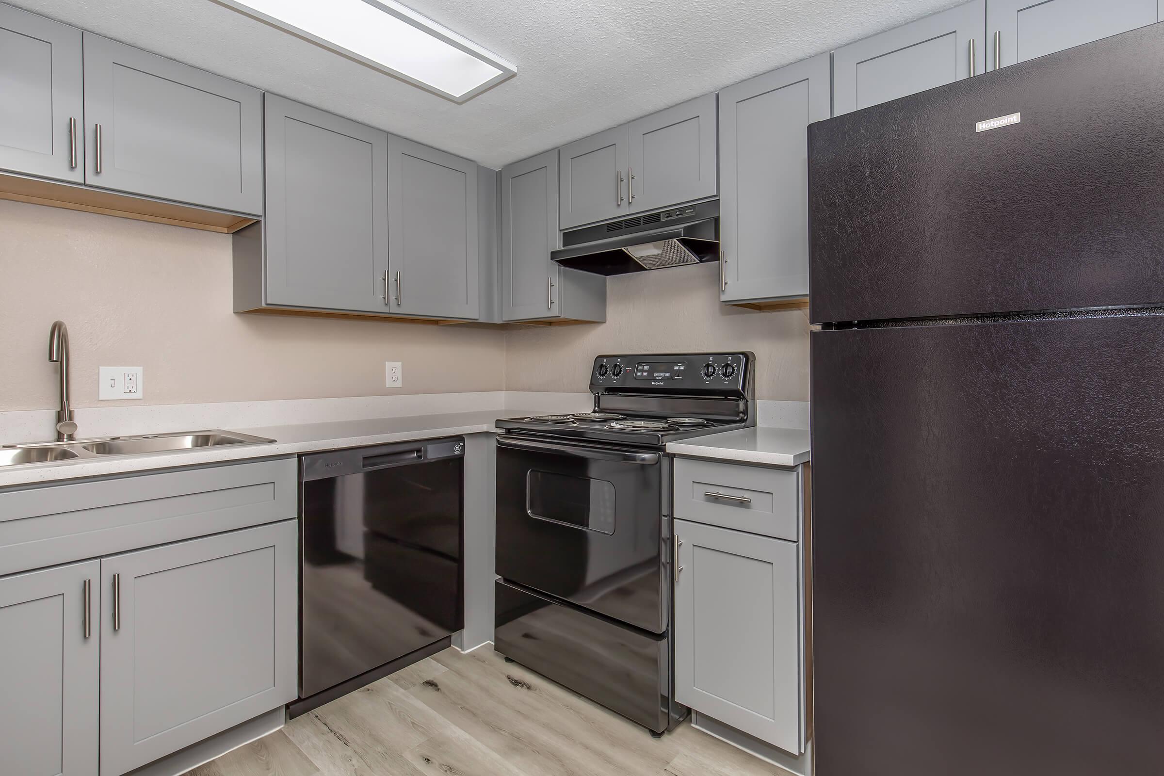 a kitchen with a stove and a refrigerator