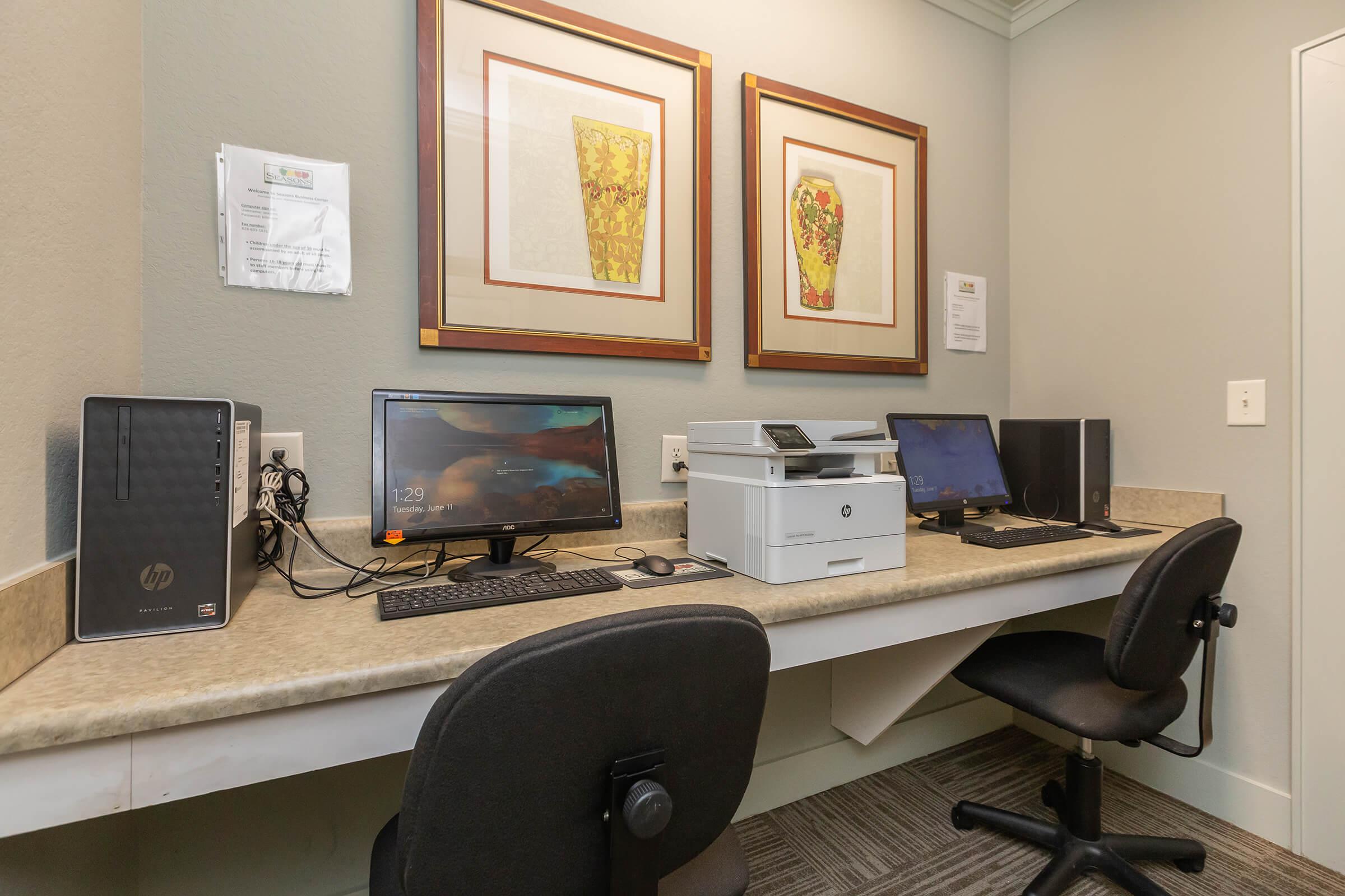 a desk with a computer on a table