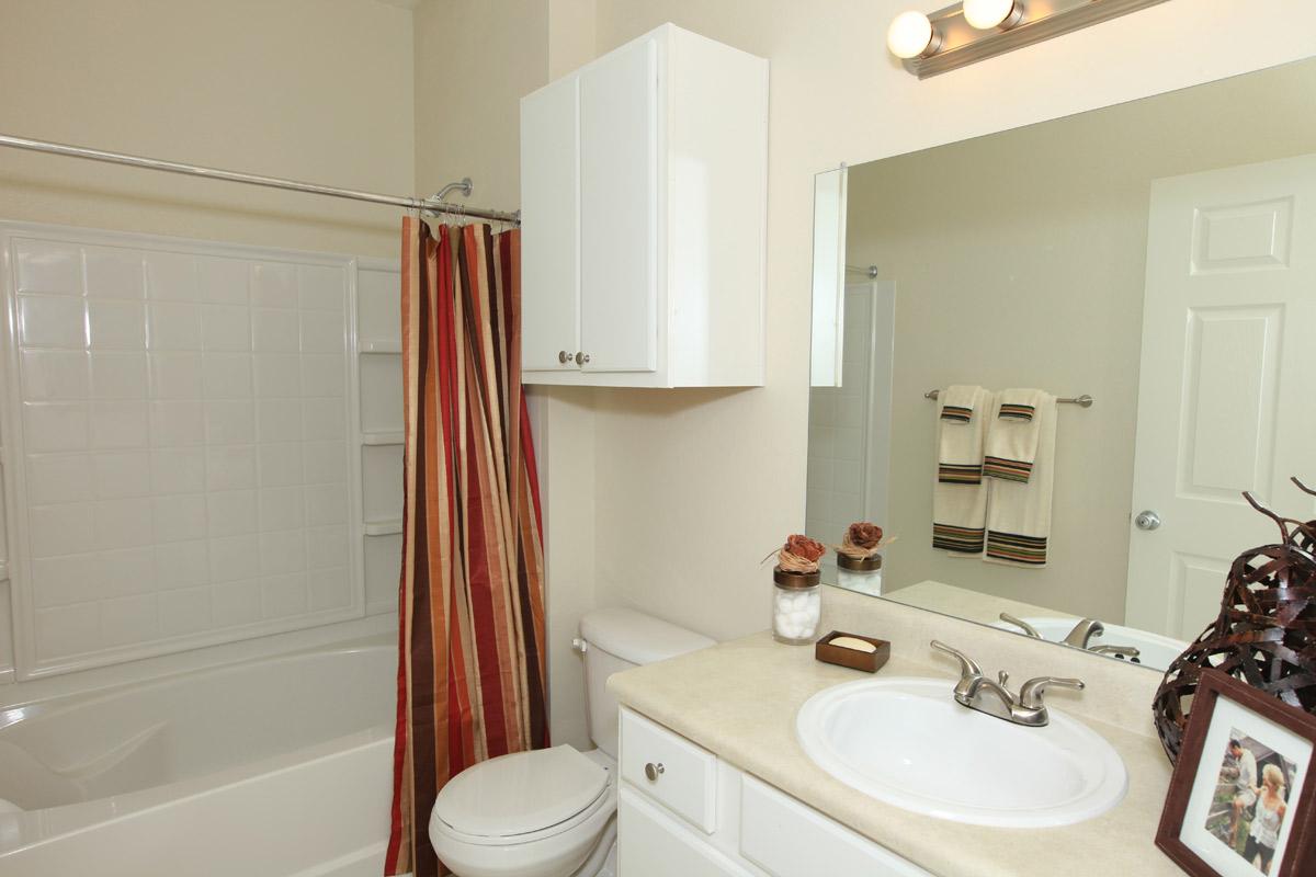 a white tub sitting next to a sink