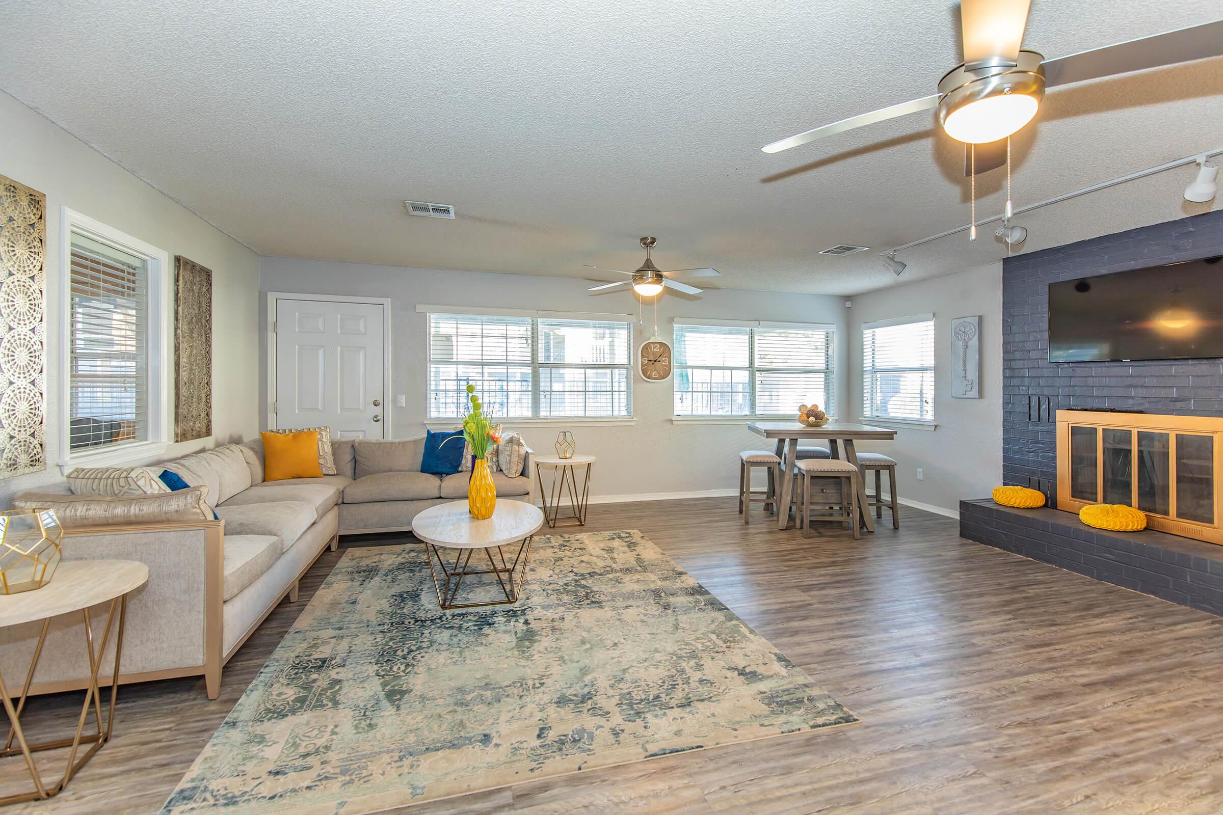 a living room filled with furniture and a large window