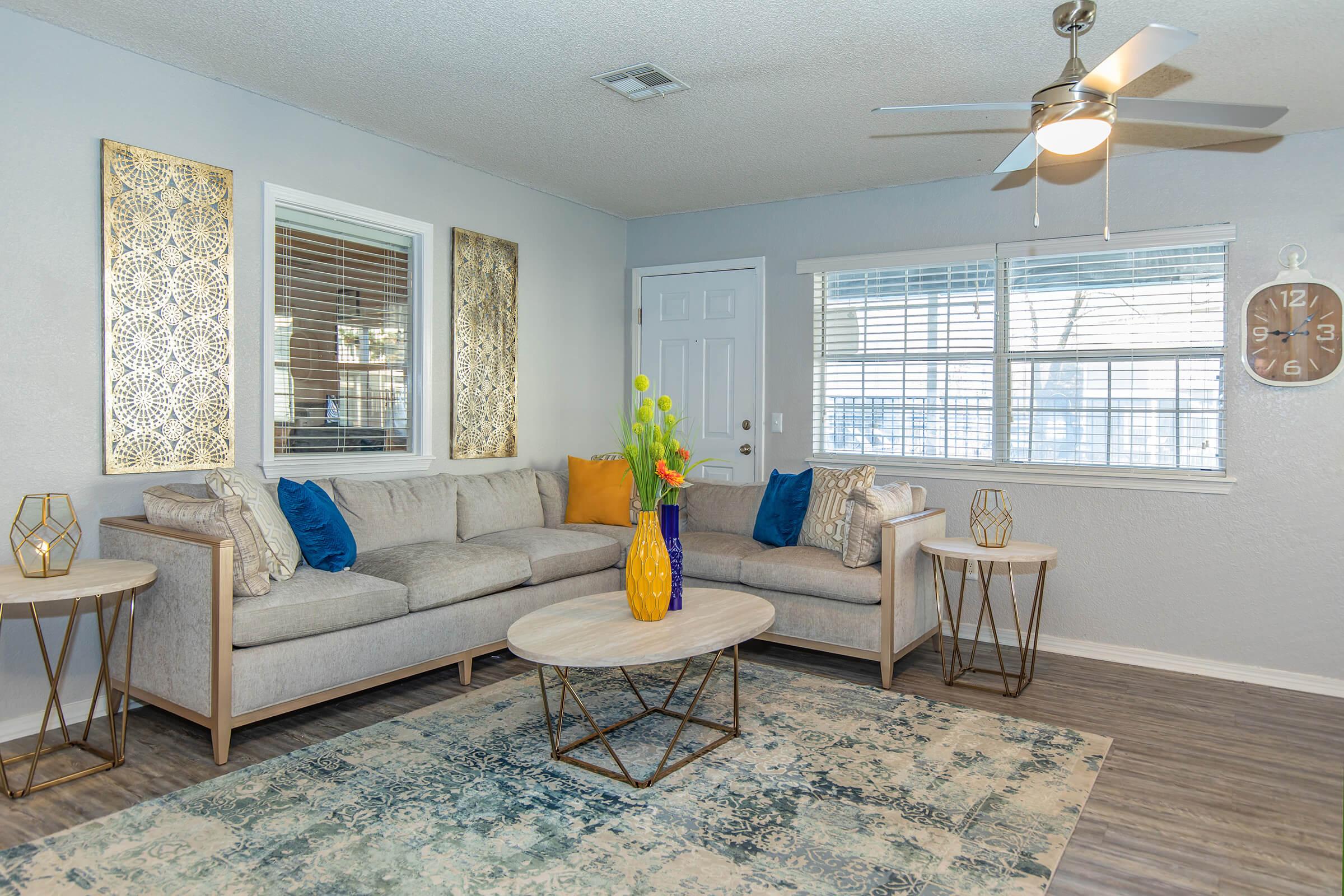 a living room filled with furniture and a large window