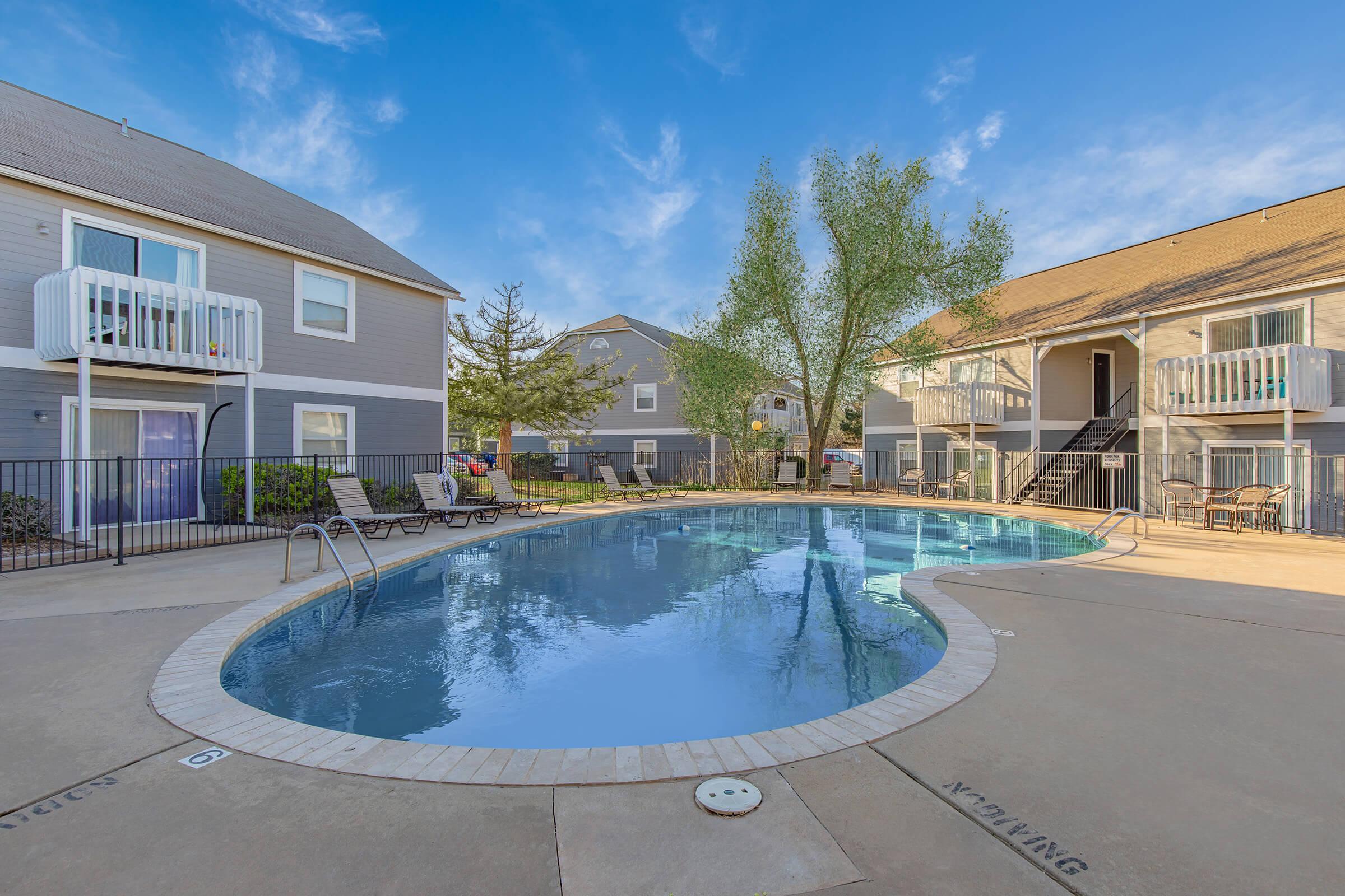 a house with a pool in front of a building