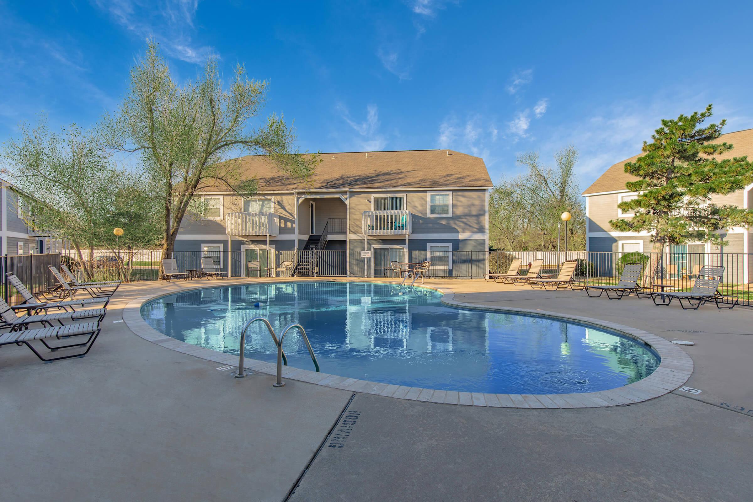 a blue pool of water in front of a house