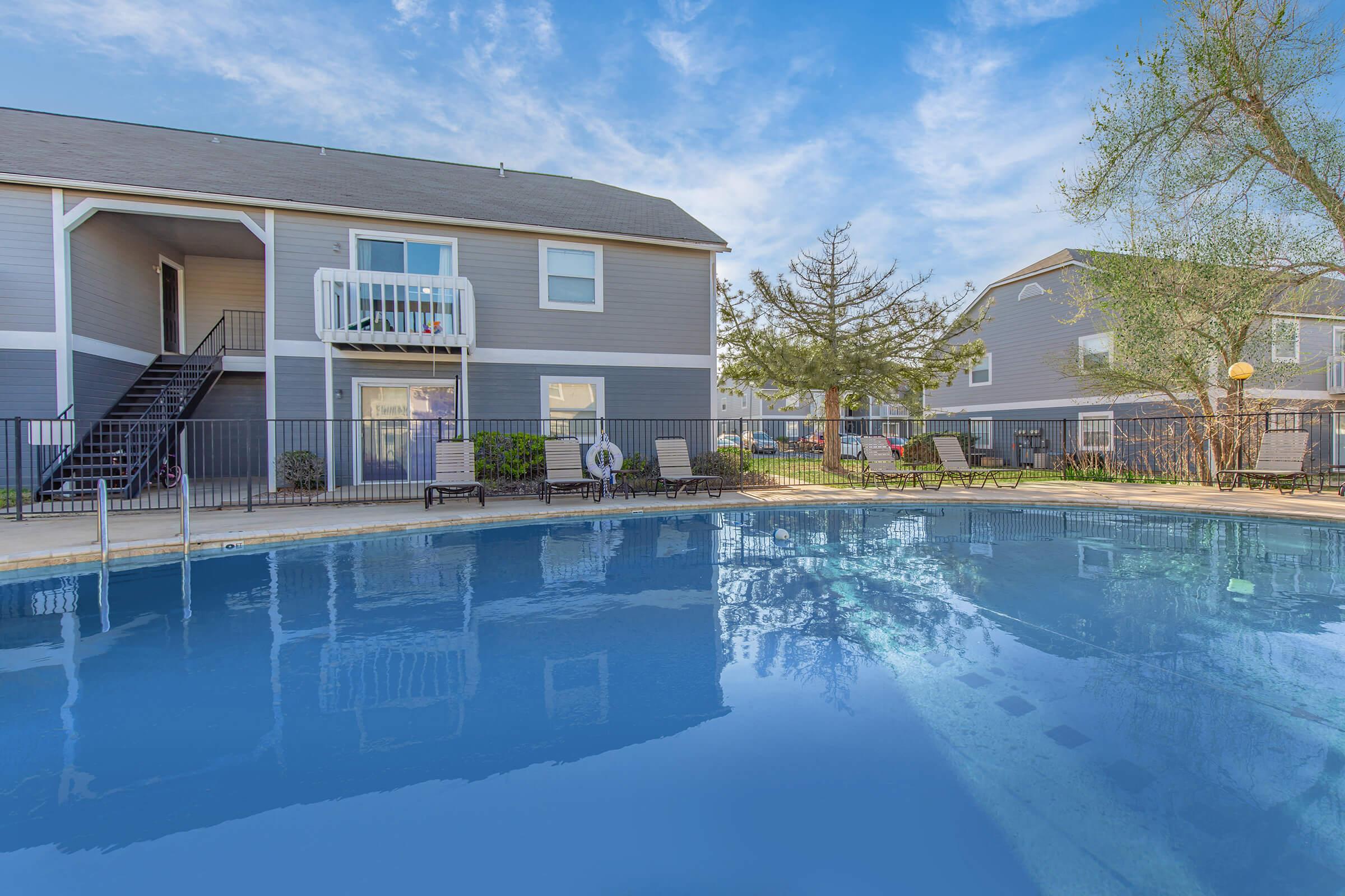 a large pool of water in front of a house