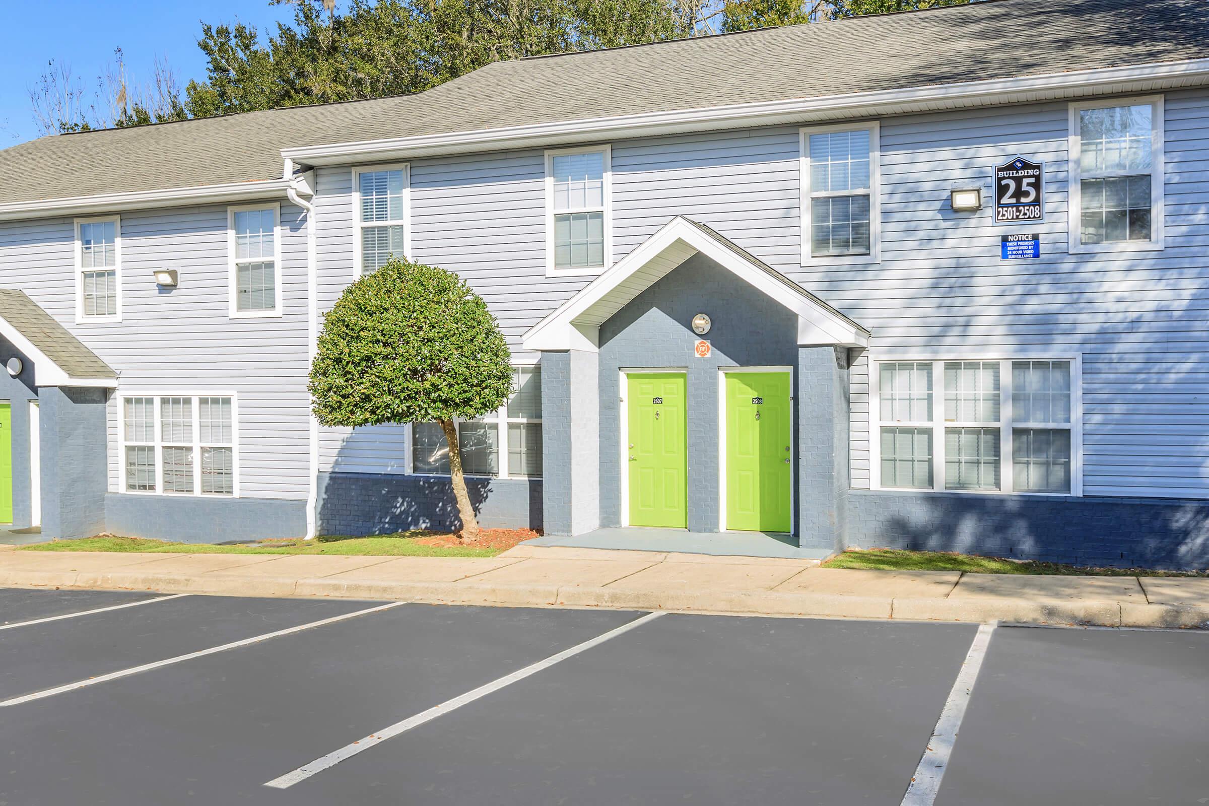 a large empty parking lot in front of a house