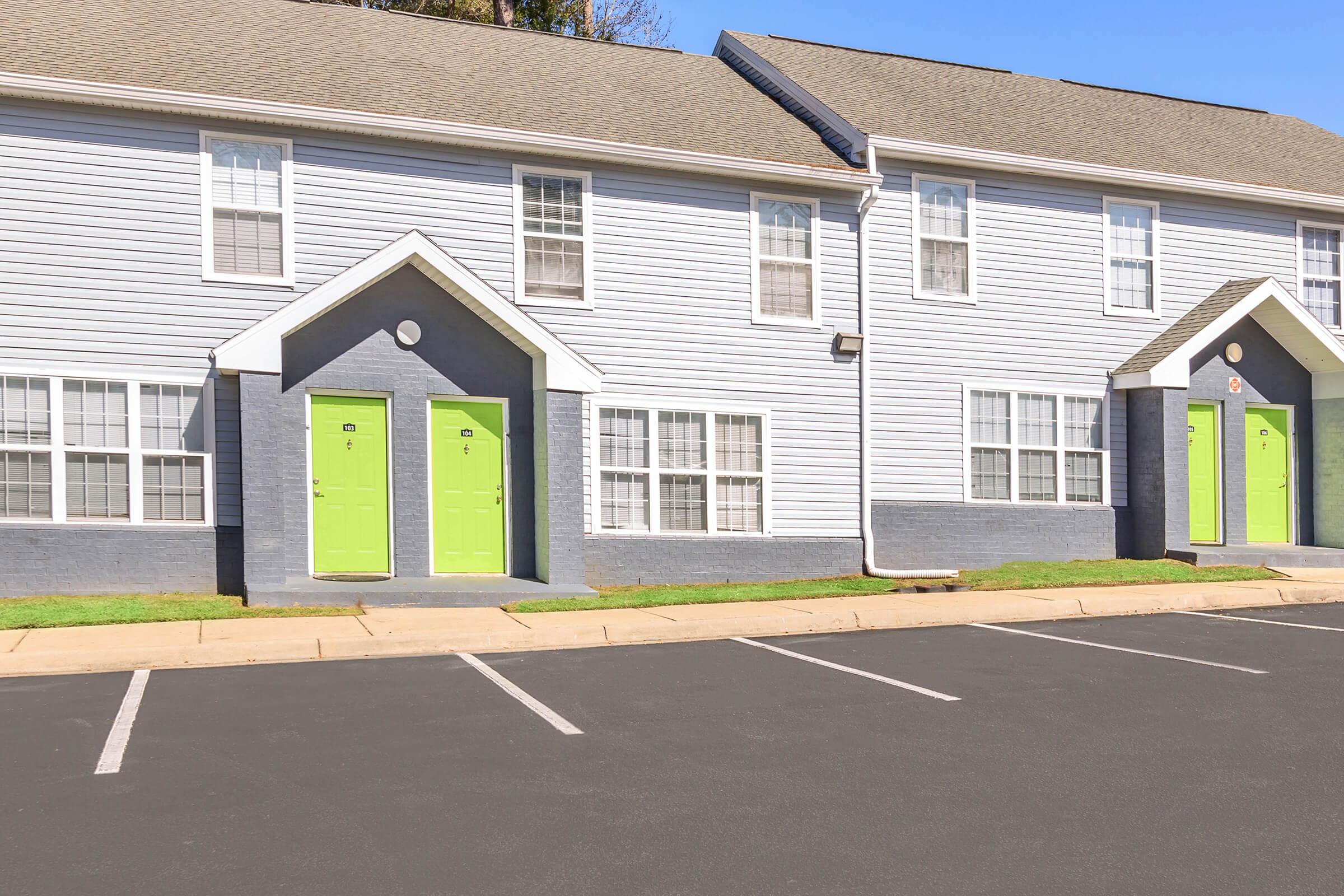 an empty parking lot in front of a house