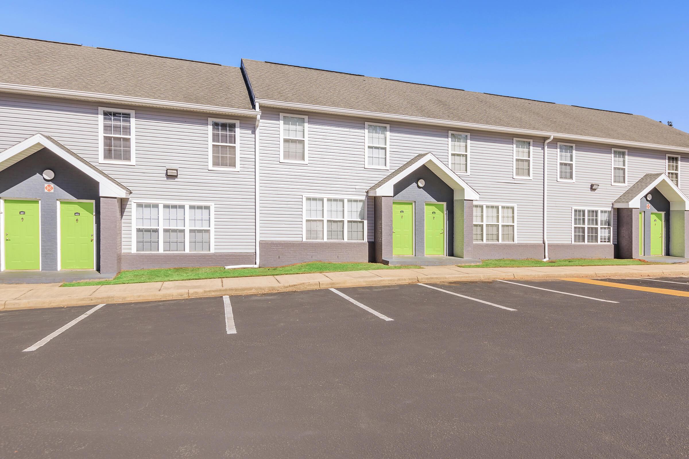 an empty parking lot in front of a house