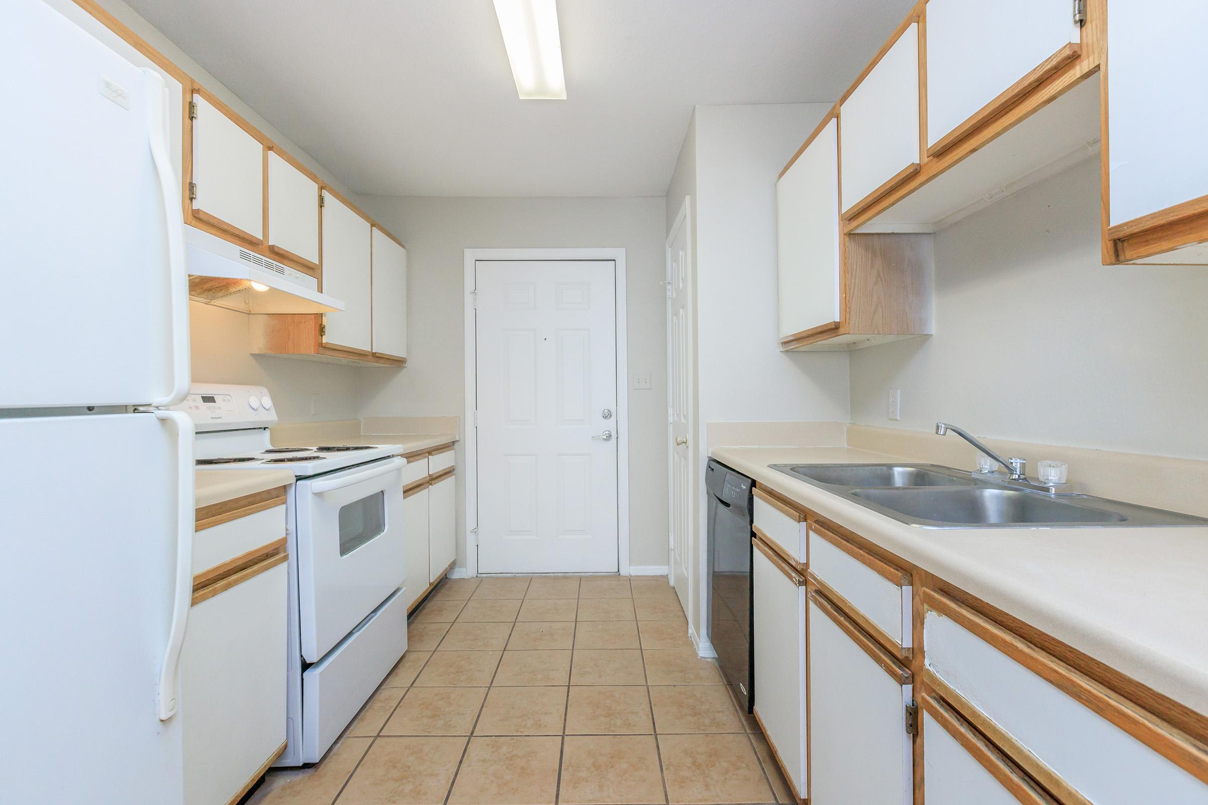 a kitchen with a stove sink and refrigerator